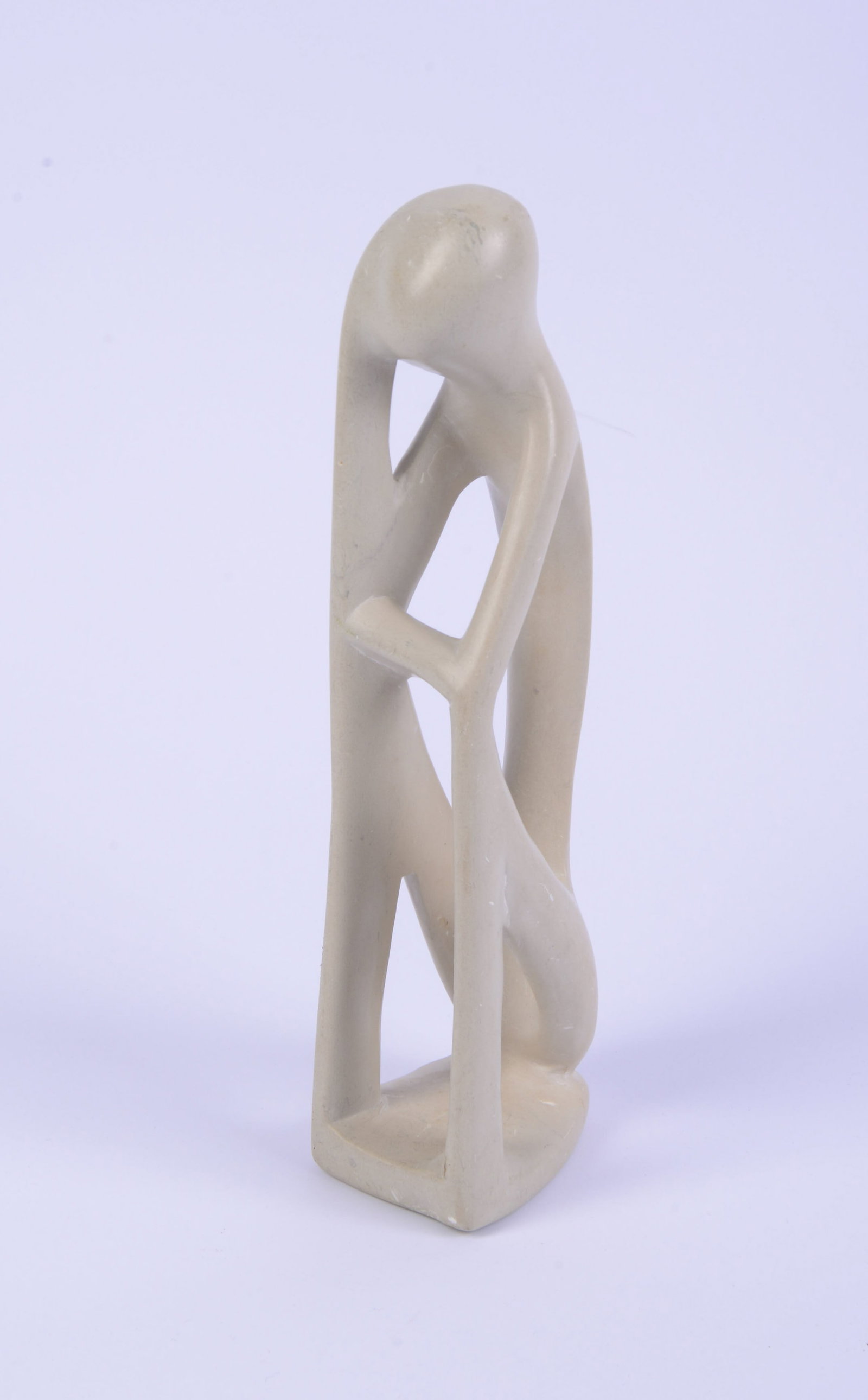 Carved Soapstone Sculpture of a Seated Figure.: Height 10.5 inches.