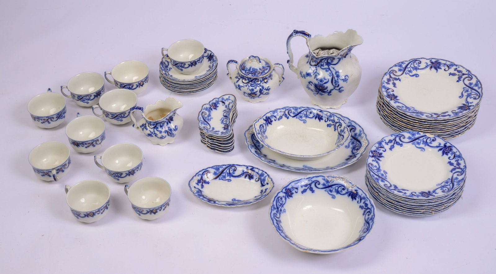Collection of Blue Willow Porcelain.: Pitcher, Johnson Bros, height 8 inches, and various cups, saucers and plates.