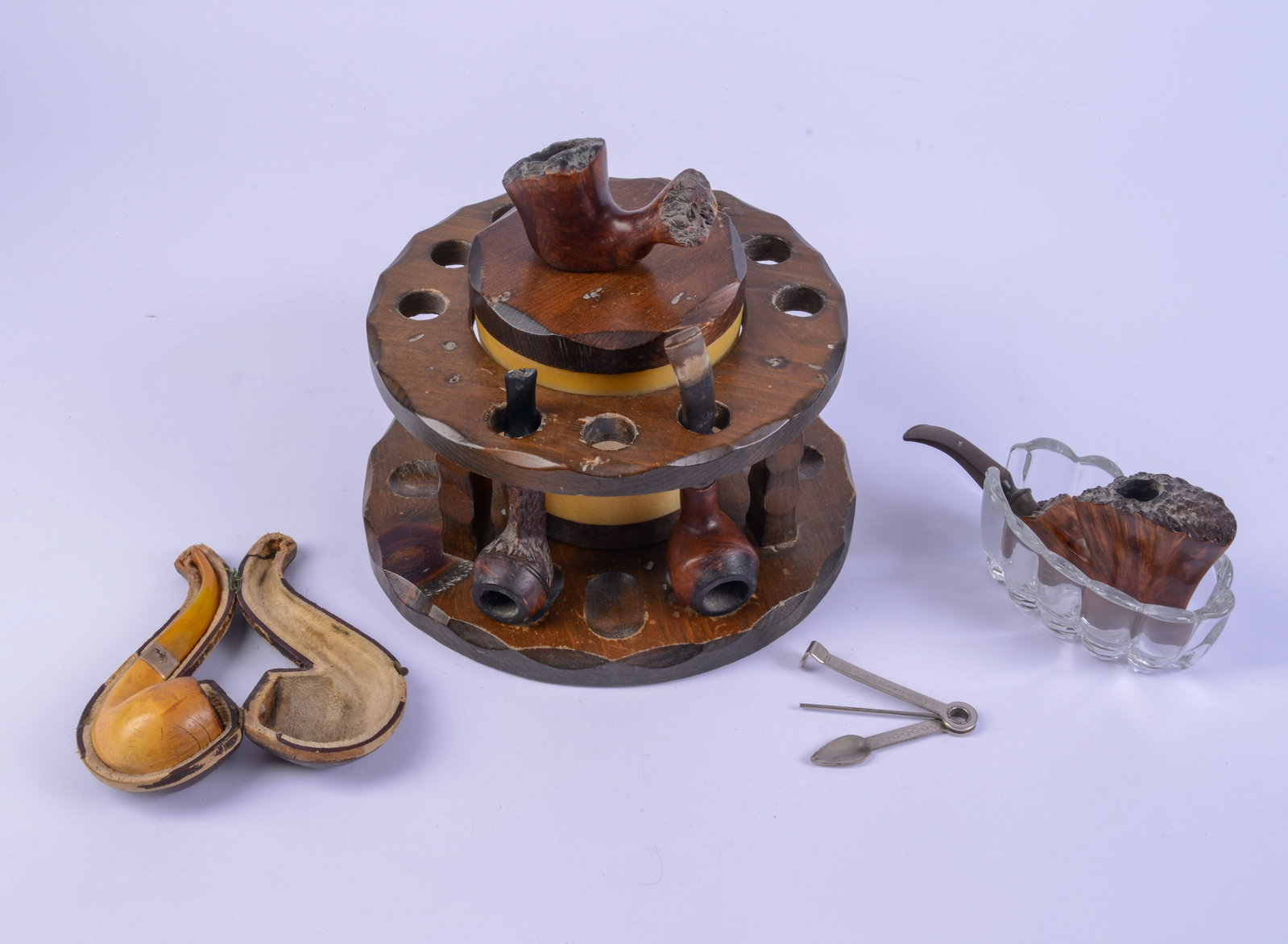 Collection of Pipes and Related Items.: Six pipes, a stand, and an ashtray. Includes meerchaum pipe with sterling band in original case.