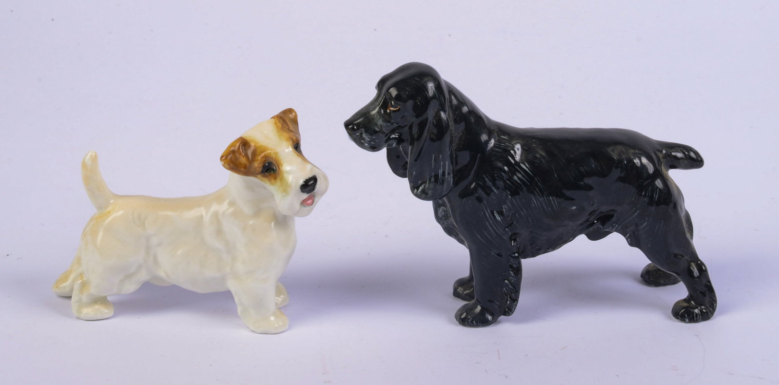 Two Royal Doulton Porcelain Dogs.: Lengths 3.5 and 4.5 inches.