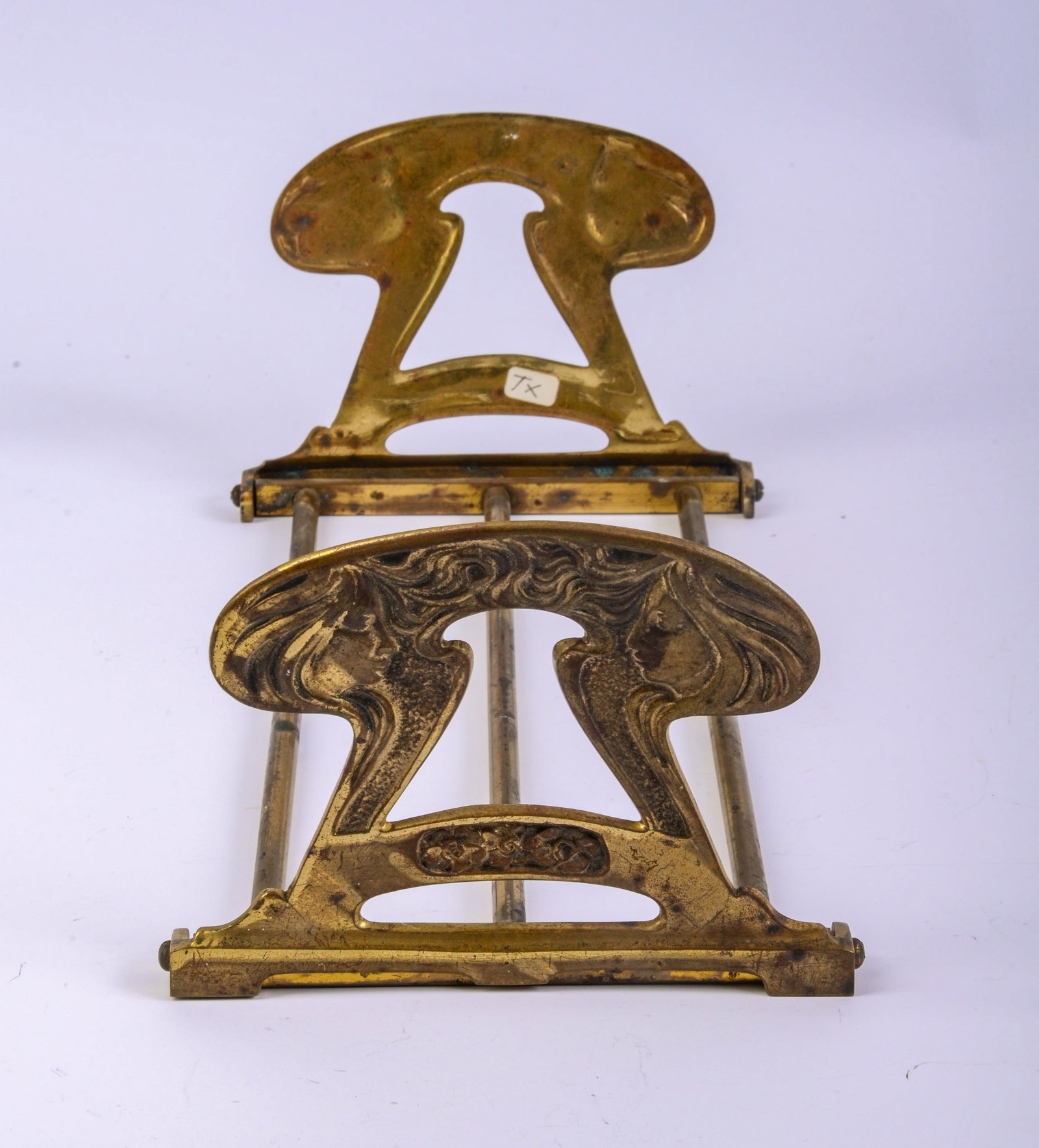 Art Nouveau Brass Bookends.: Height 4.75 inches, length 12 to 23 inches.