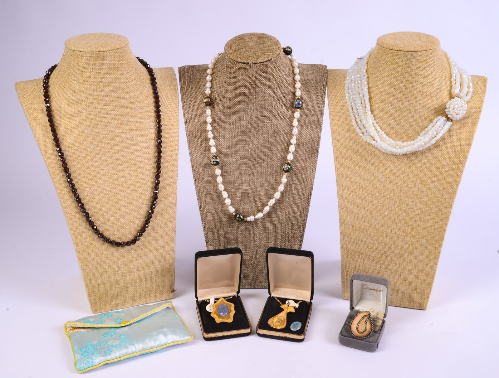 Collection of Jewelry.: Includes two freshwater pearl necklaces, lengths 16 and 22 inches, a fossil ring, red beaded necklace, and two pendant necklaces.
