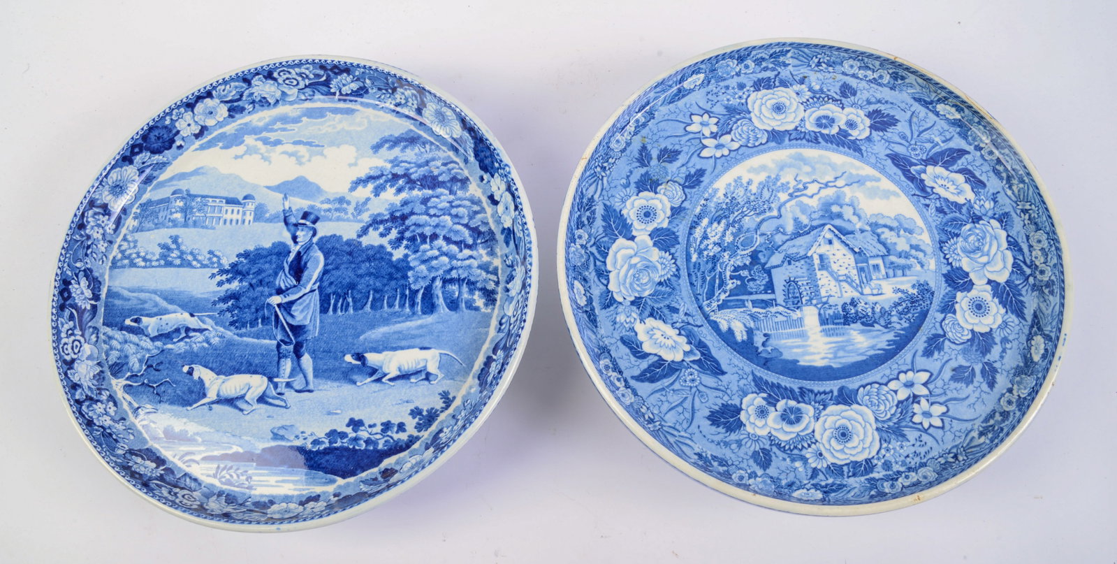 Two Blue and White Porcelain Cake Stands.: One game keeper, diameter 11.75 inches, the other with a mill, diameter 11.25 inches. Good condition.