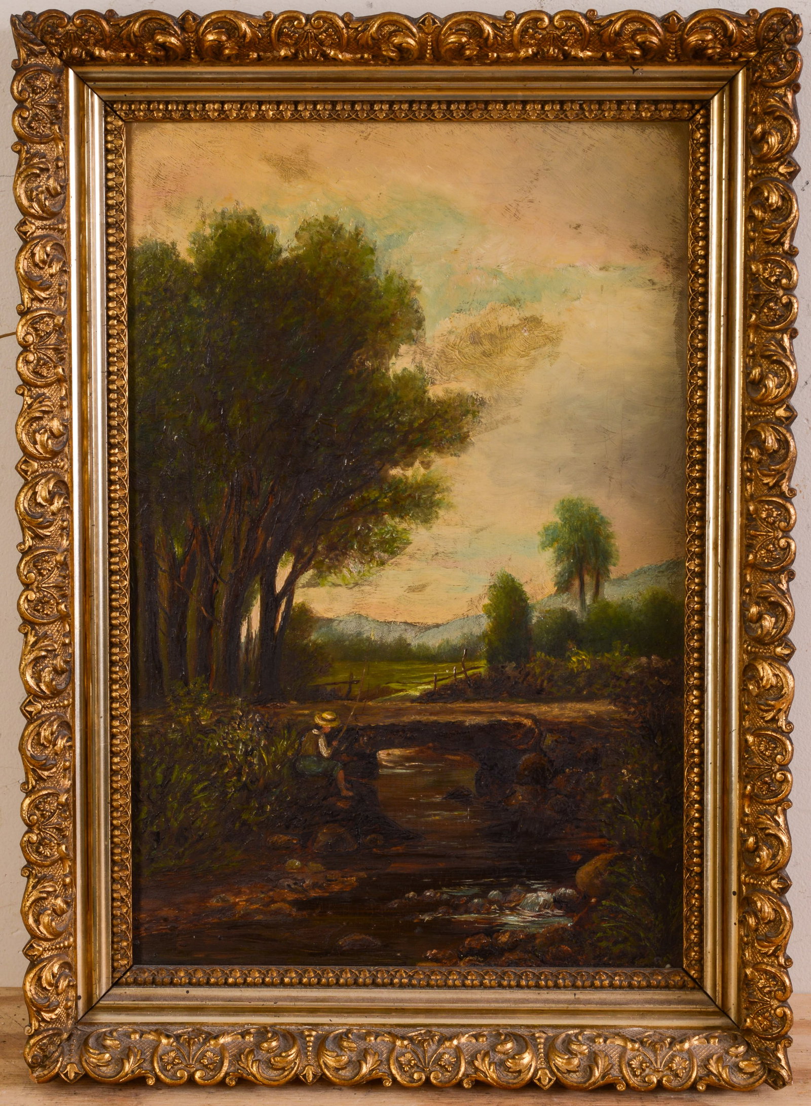 Early 20th Century Painting of a Boy Fishing.: Oil on canvas, 18 x 12 inches. In a period gilt frame, 21.5 x 15.5 inches.