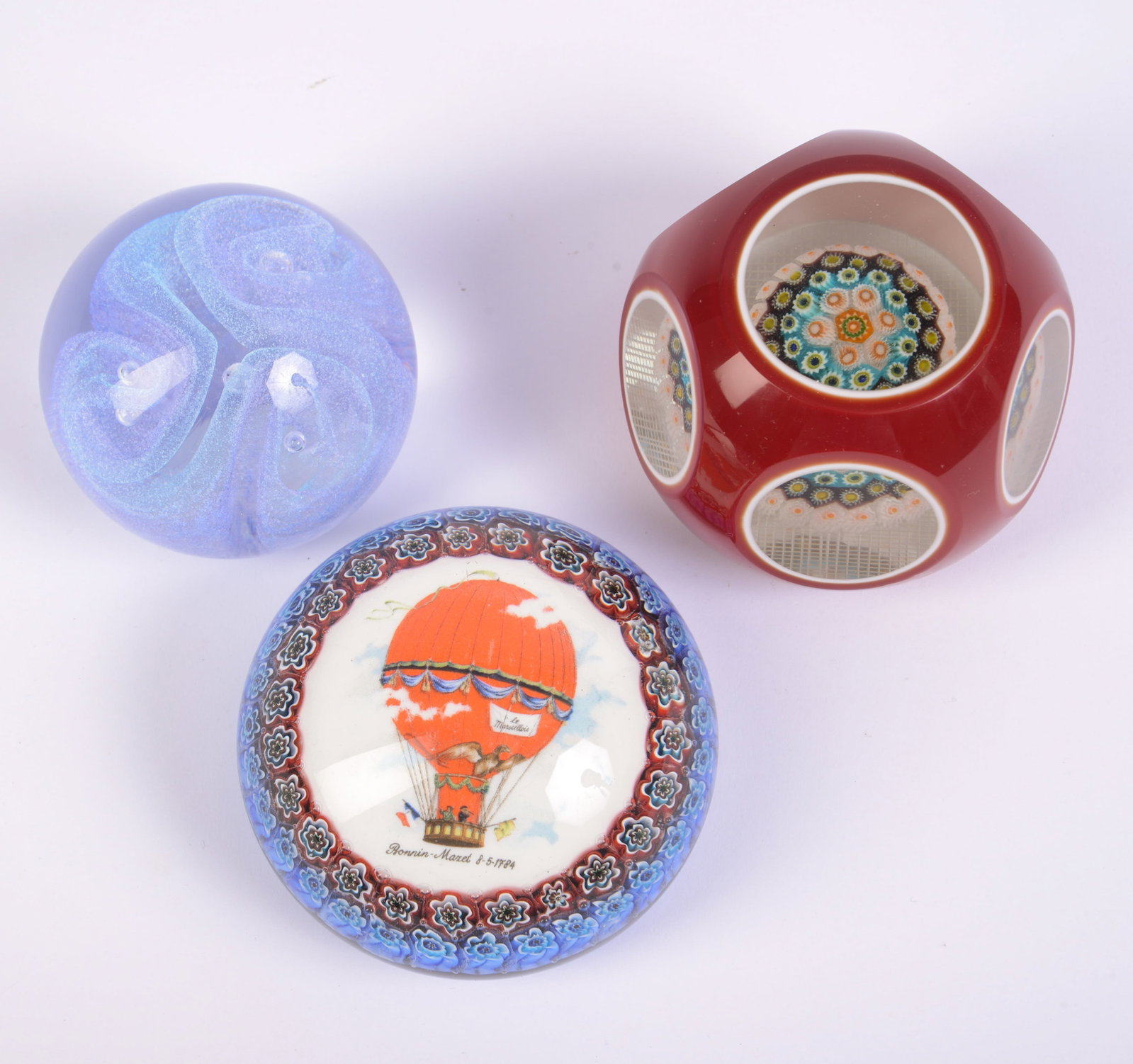 Three Glass Paperweights.: Diameters 2.75 to 3.5 inches.