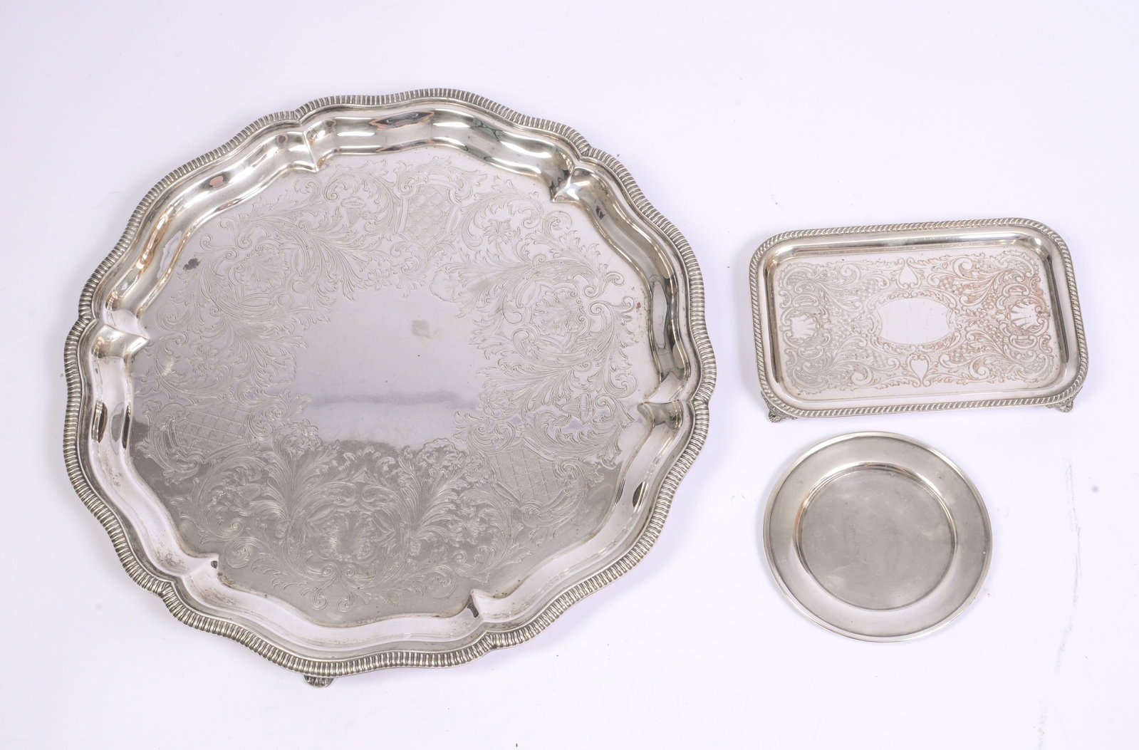 Three Silverplate Trays.: Largest diameter 18 inches.