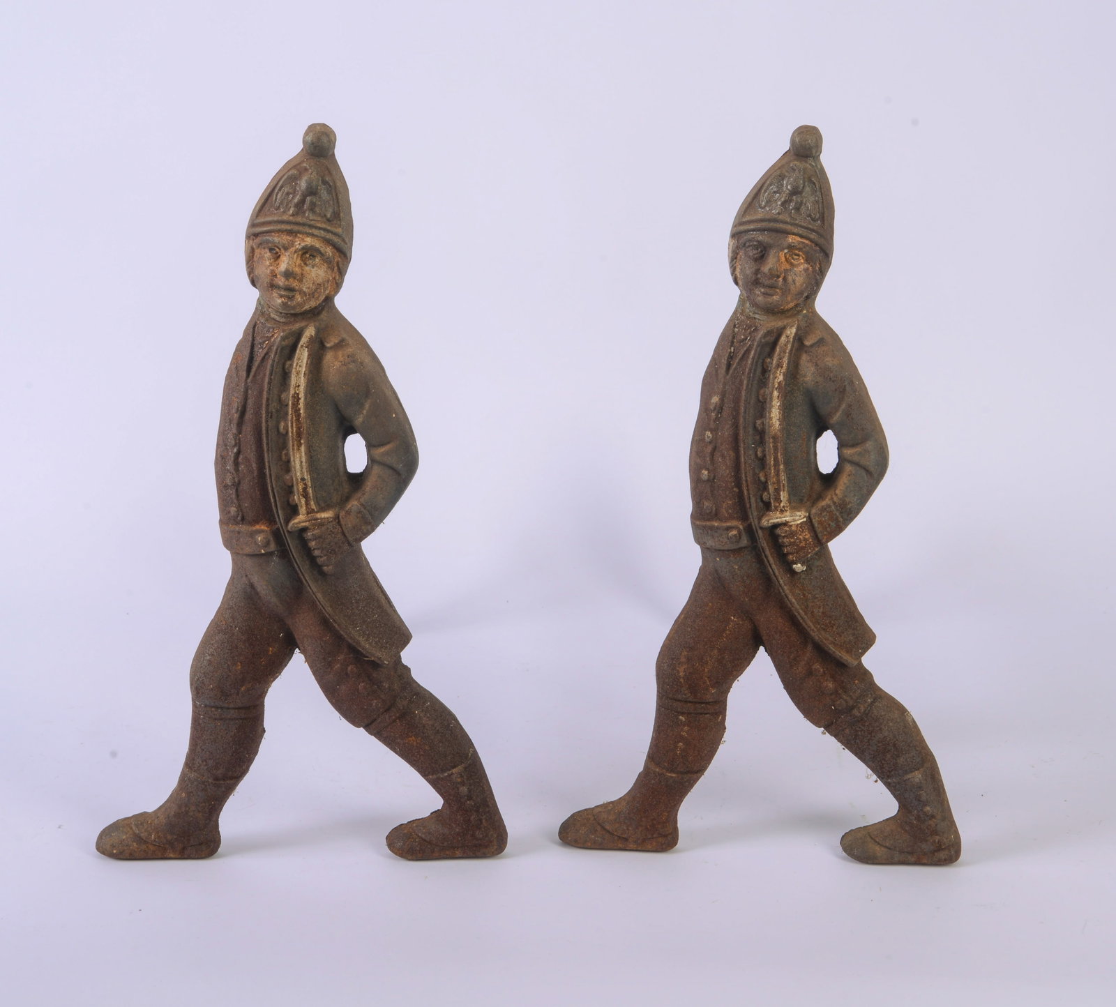 Pair of Cast Iron Hessian Andirons.: Height 20 inches, width 10 inches, depth 19 inches.