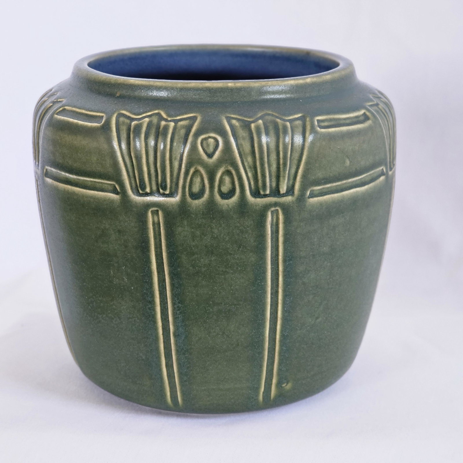 Arts & Crafts Style Vintage green pot: Markings on base PK, University of North Dakota periwinkle interior, variation in outer glaze.Pot measures approximately 5 1/2" tall, 6" diameter at the widest point, 4" diameter opening.