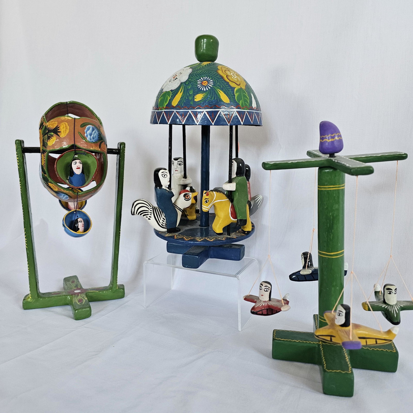 Grouping of Folk Sculptures of Carnival rides: Handmade and painted all have some sort of movement in the design, from Central/South American origin, no markings.