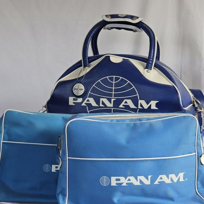 Group of Pan Am Bags: Two smaller and one larger tote. Varying shades of Pan Am blue, Gym and flight bags. Condition is good to fair on the smaller bags.