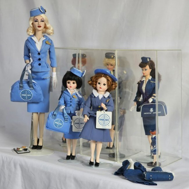 Group of Stewardess Dolls: Group of 6 various stewardess doll, American Airlines, Pan Am in various sizes and models of which two are Madame Alexander, and a spare American Airlines outfit. Additional plastic figurines in clear
