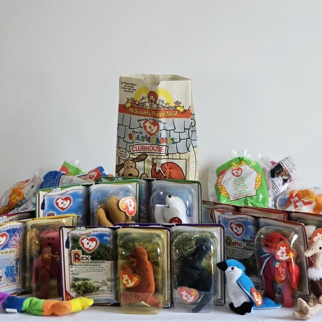 Lot 33 of TY McDonald's Toy Beanie Babies: Group of Ty toys. 9 still packaged in blister packs, and 24 others loose with open original plastic bags. Beanie Babies from Dinosaur Trio, International Bears II, Legends, House Charities, etc.