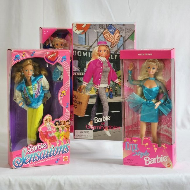 Barbie group of 4 includes Bloomingdale's: Boxed stylish barbies features, City Style, Graduation Barbie and others all in boxes.