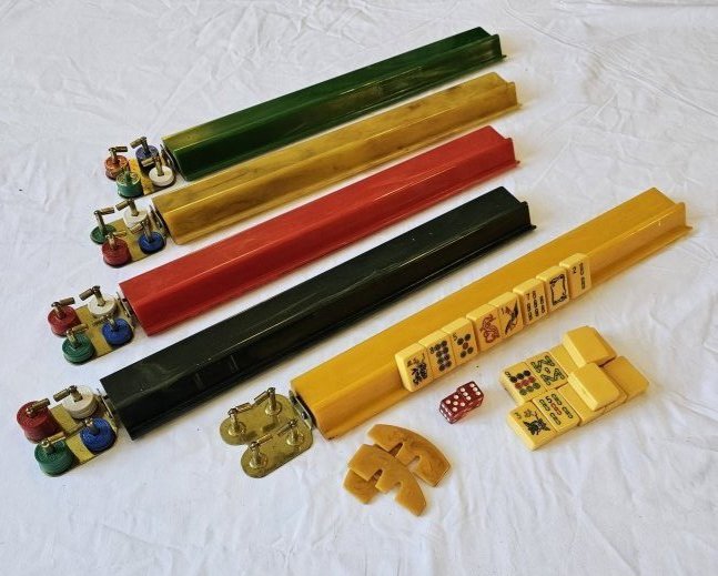 Set of Vintage Bakelite Mahjongg Tiles and Racks: Set of Bakelite Mahjongg tiles and racks. There are 164 tiles, 5 racks in various colors, chips, and dice along with a carrying case.There is wear and staining to the tiles, but otherwise everything i