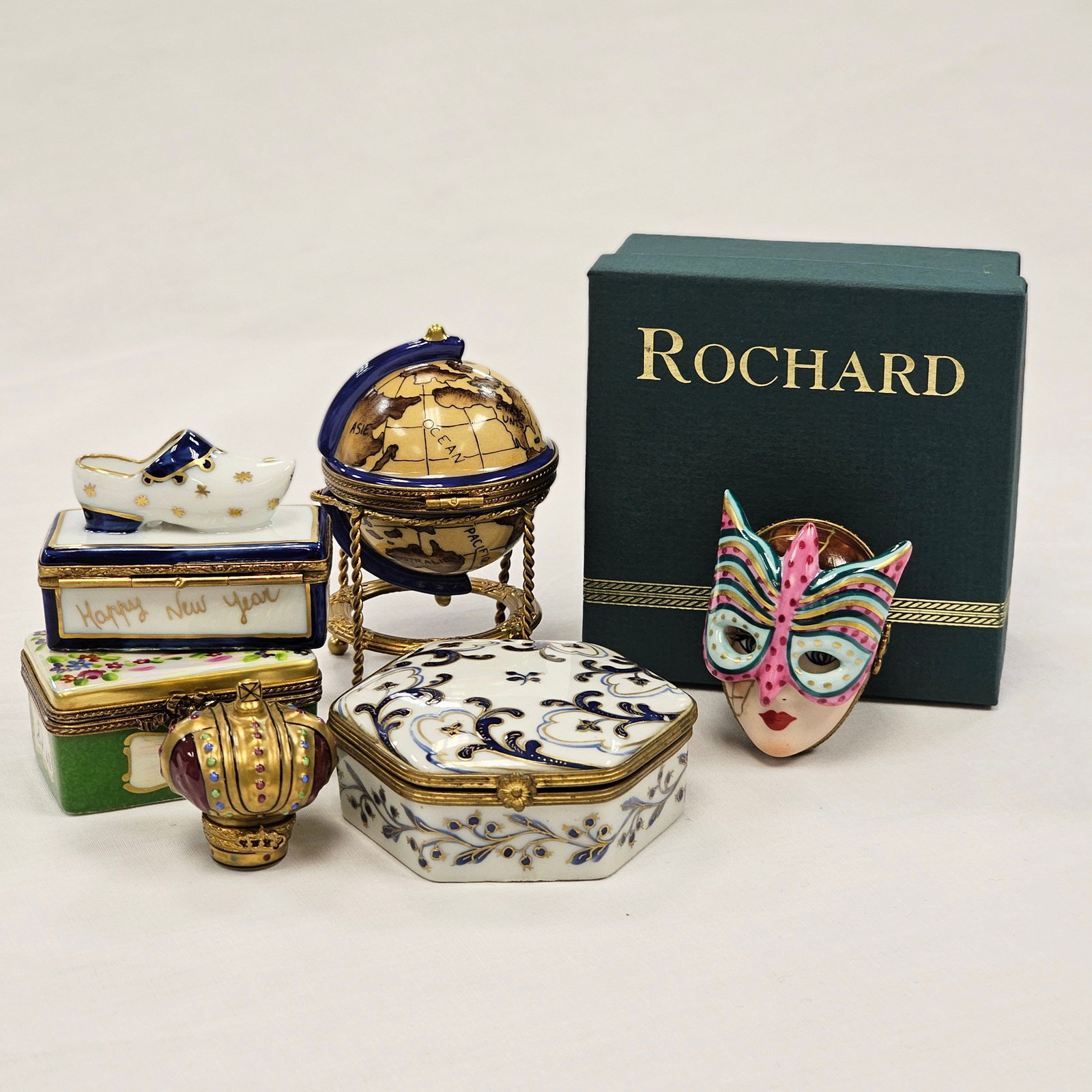 Grouping of Limoges Paris Boxes, some for Rochard and Tiffany: Grouping of Limoges Paris trinket boxes, some for Tiffany and Rochard including a masquerade mask, globe, and other boxes. All signed/stamped.