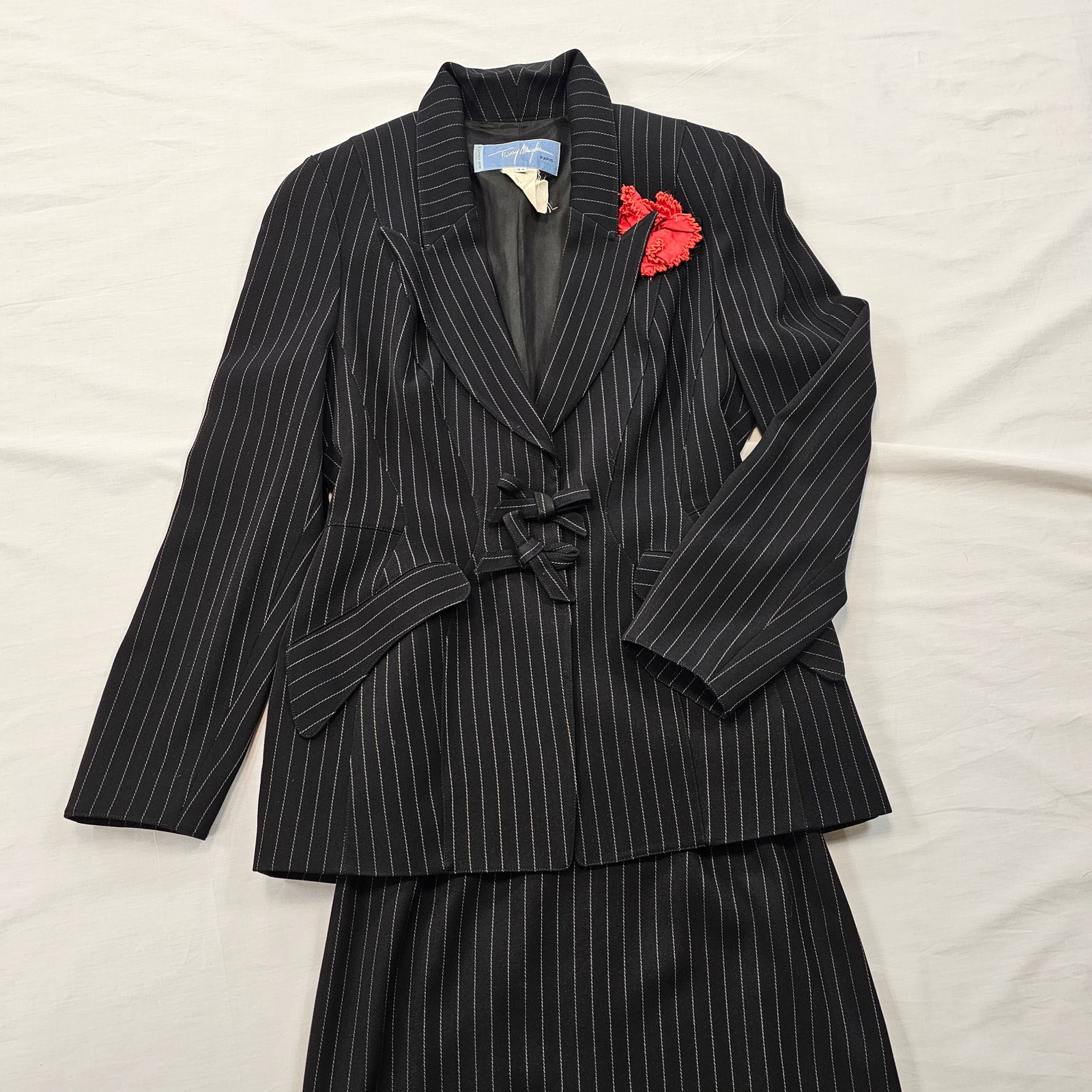 Thierry Mugler Black and White Pinstripe Skirtsuit: Theirry Mugler pinstripe skirt suit with red flower brooch accent.