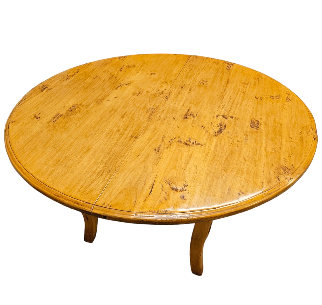 French Provincial Fruitwood Dining Table: The round top, with one leaf, raised on boldly carved cabriole legs. 29in. (73cm) h. 53in. (diameter) leaf 19in.(48cm) Condition: Very good.