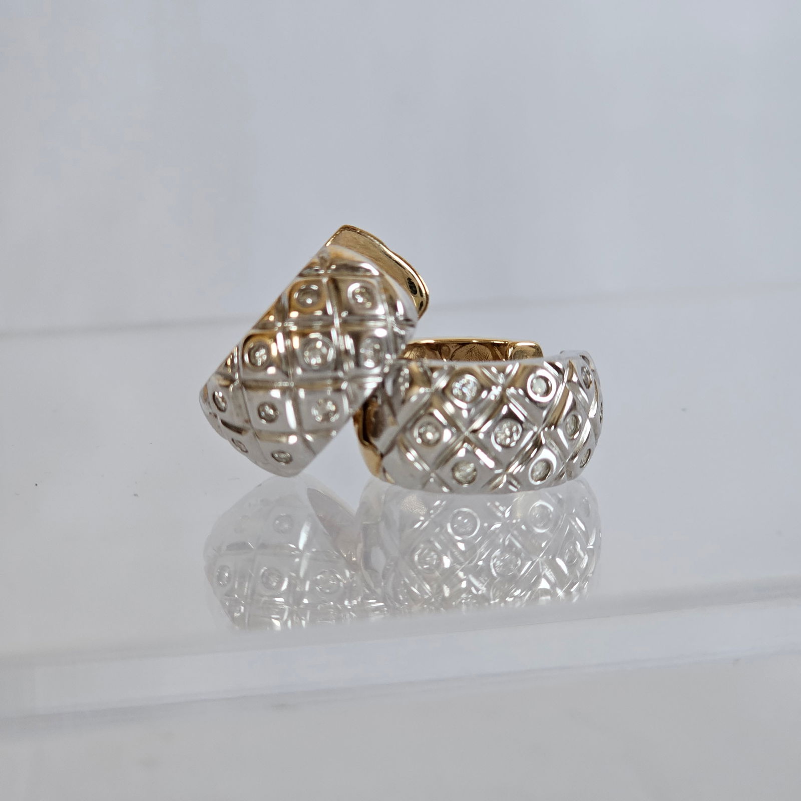 Pair of Diamond, 14k White and Yellow Gold Hoop Earrings: Each featuring ten full-cut diamonds weighing a total of approximately 0.20 cttw., set in a quilt-textured 14k yellow and white gold hinged hoop earring mounting measuring approximately 20.5 mm (0.80