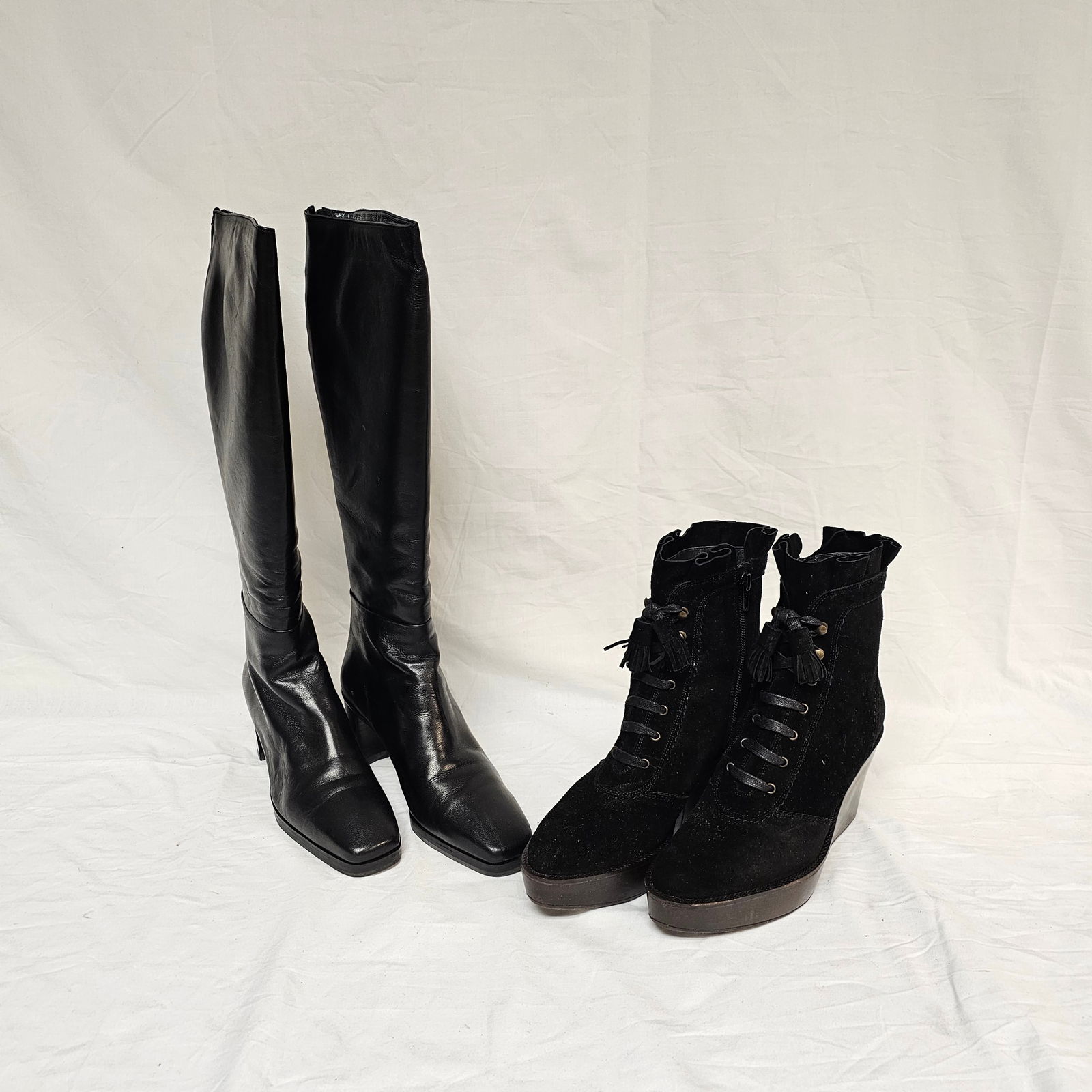 Group of 2 Pairs Stuart Weitzman Shoes: 2 pair of Stuart Weitzmann ladies' knee-high leather boots and wedge boots with lace up and rubber soles. The size for the tall boots is 5.5 and for the short boots is 5. Condition is good on both