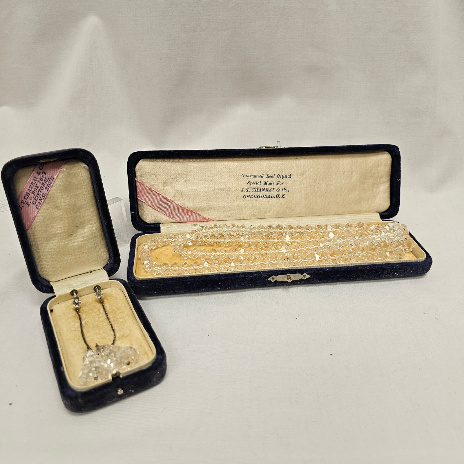 Vintage Crystal Jewelry Group J.T. Chanrai & Co.: Both in cases. Crystal faceted bead necklace, with screw-back earrings with graduated cone shape also of faceted crystal. 