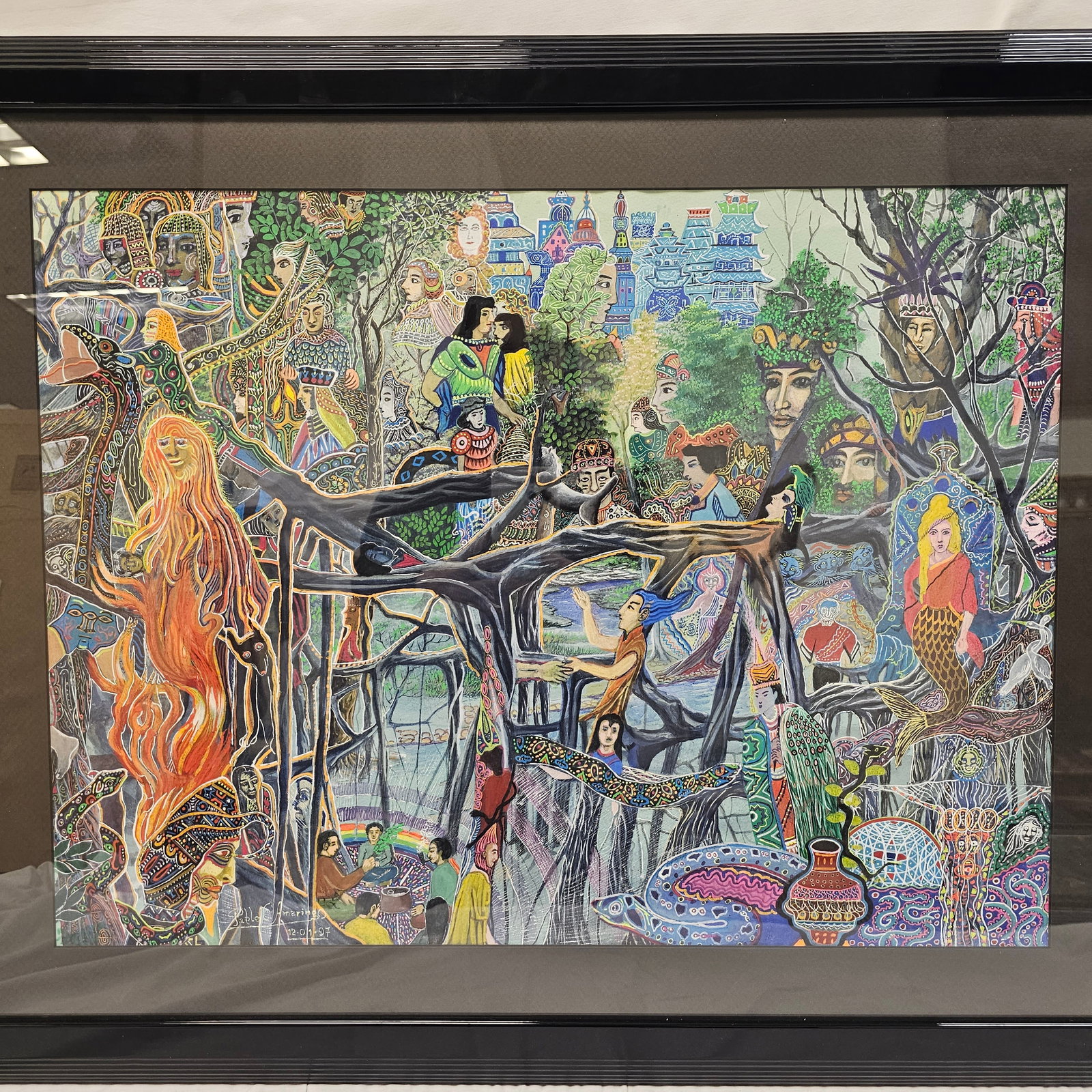 Pablo C. Amaringo (Peruvian) '97: Pablo Cesar Amaringo Shuña, art on paper river and trees intertwined with mystical, figures full of colorful patterns, with equally colorful and detailed buildings in distance. With frame 