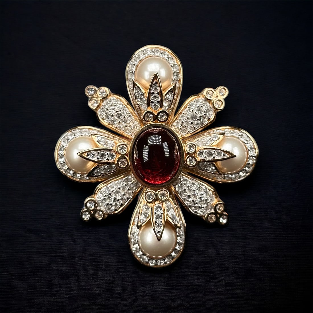 Vintage Ciner Glass, Simulated Pearl, Rhinestone Pin Pendant: Designed as a cross, centering an oval glass cabochon highlighted by four round simulated pearls and numerous colorless rhinestones, set in a gold-tone pin pendant mounting measuring approximately 2.7