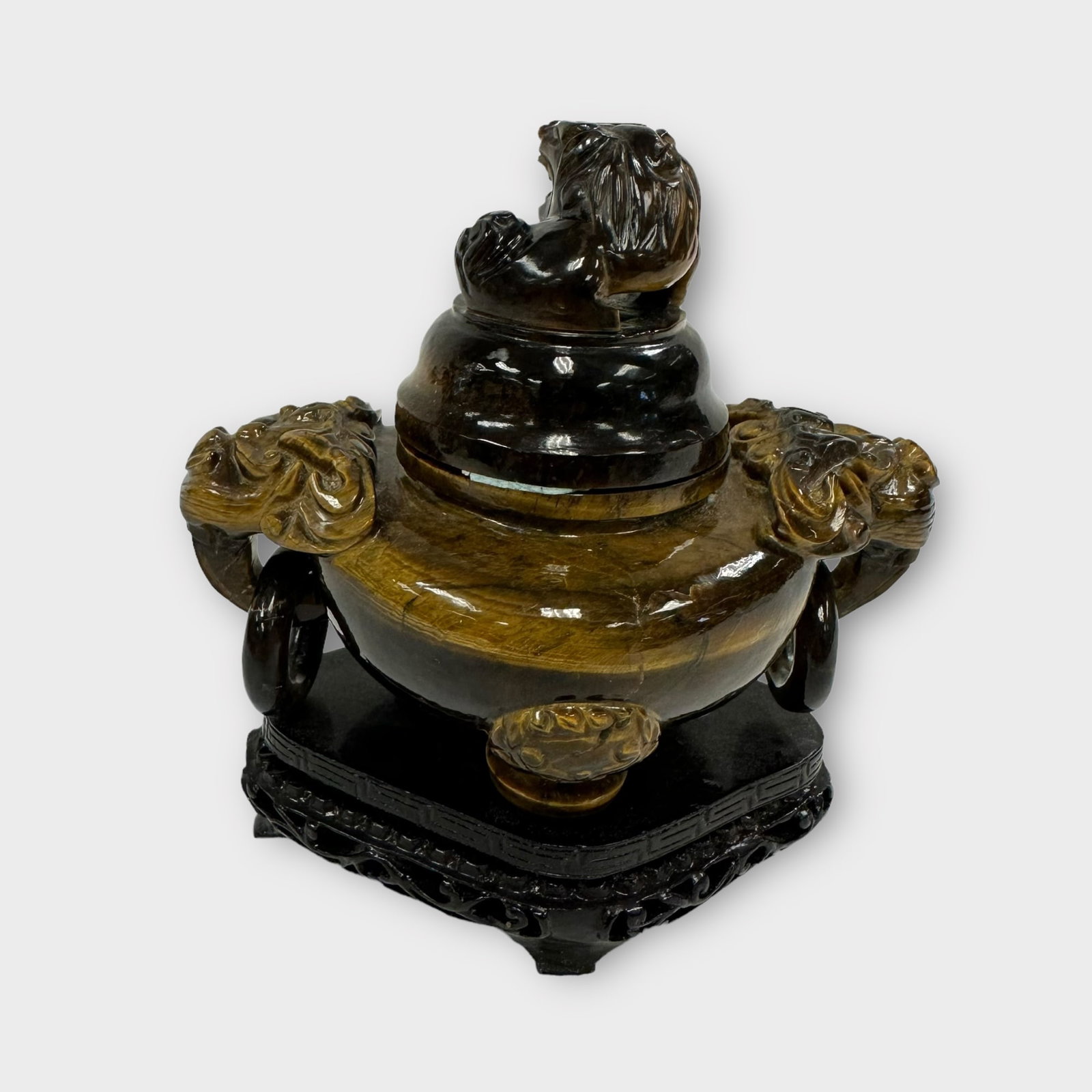 Carved Tiger's Eye Tripod Censer: A carved tiger's eye tripod censer, China, 20th century or later. Measures approximately 5 in L x 3 in W x 4 in H (without stand) Condition is good, some museum putty holding the lid to the base.