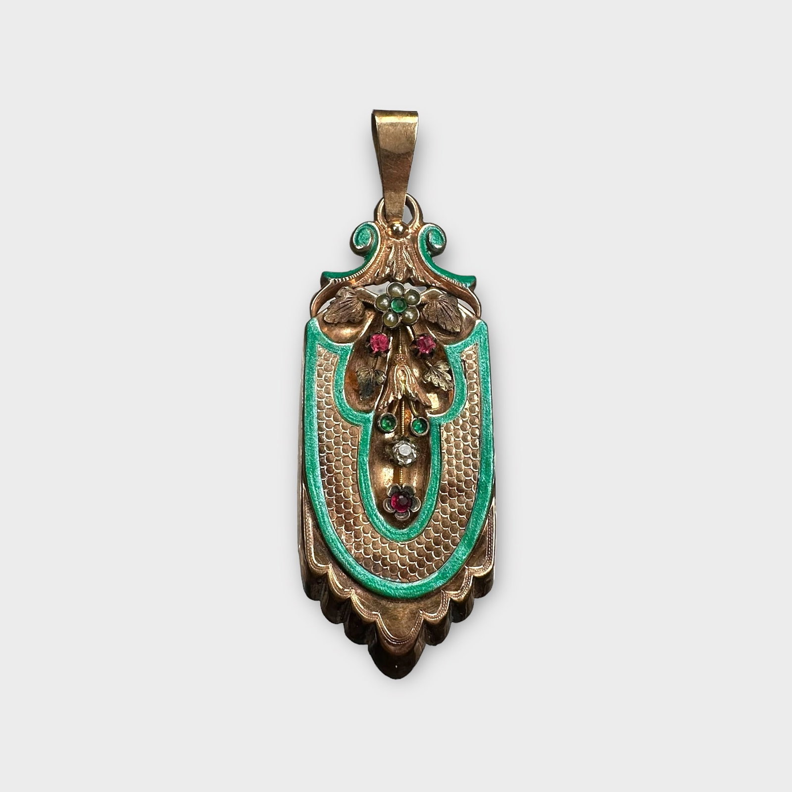Victorian Diamond, Enamel, 10k Rose Gold Locket: Centering a spray of flowers highlighted by a mine-cut diamond enhanced by seed pearls and glass stones, further accented by green enamel, set in a 10k rose gold locket mounting measuring approximatel