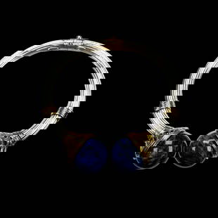 Ilias Lalaounis Sodalite, 18k, Sterling Silver Bracelet: The sterling silver, 18k yellow gold hinged clamper cuff terminating to two round, sodalite finials, inner circumference 6 1/2 inches. Gross weight: 27.8 grams. Marked "Greece, A21 925, maker'