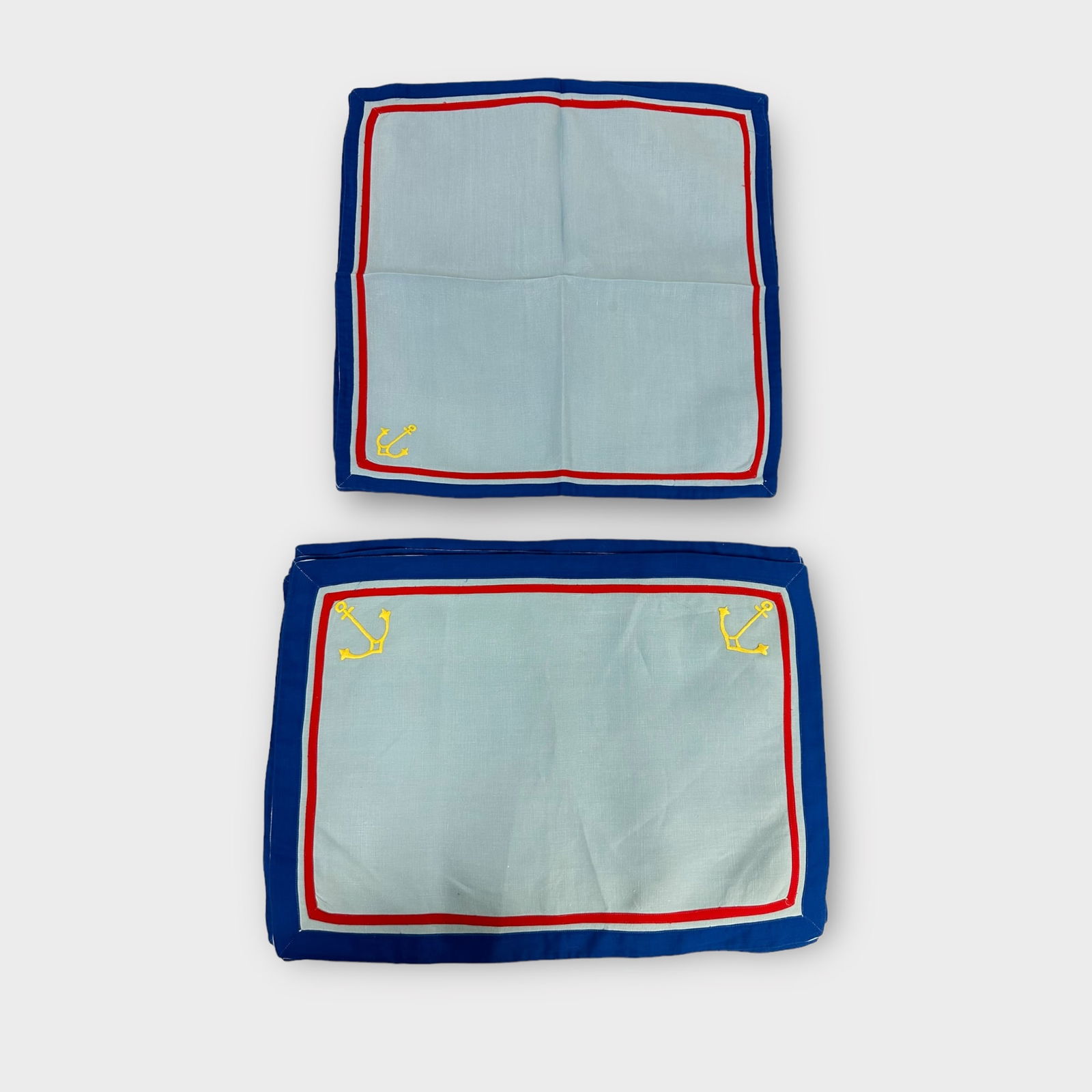 Group of Table Linens: Group of table linens including baby blue placemats and napkins with anchors. Condition is good.