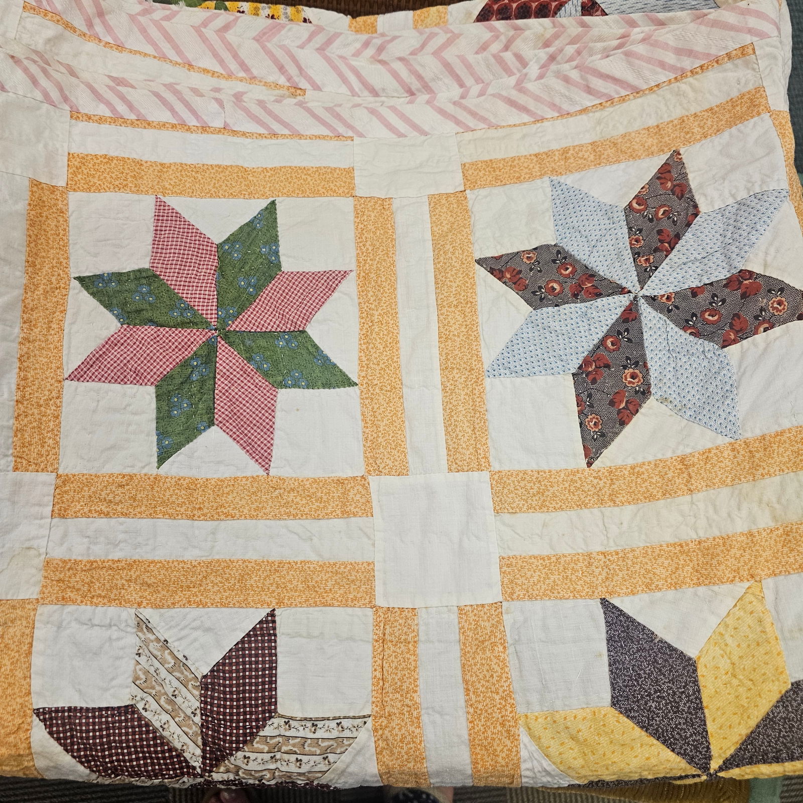 Star Quilt: Star quilt featuring 8-point stars in alternating fabric, bordered by yellow floral border. Measures approximately 74 in x 82 in. Condition is good, some staining.