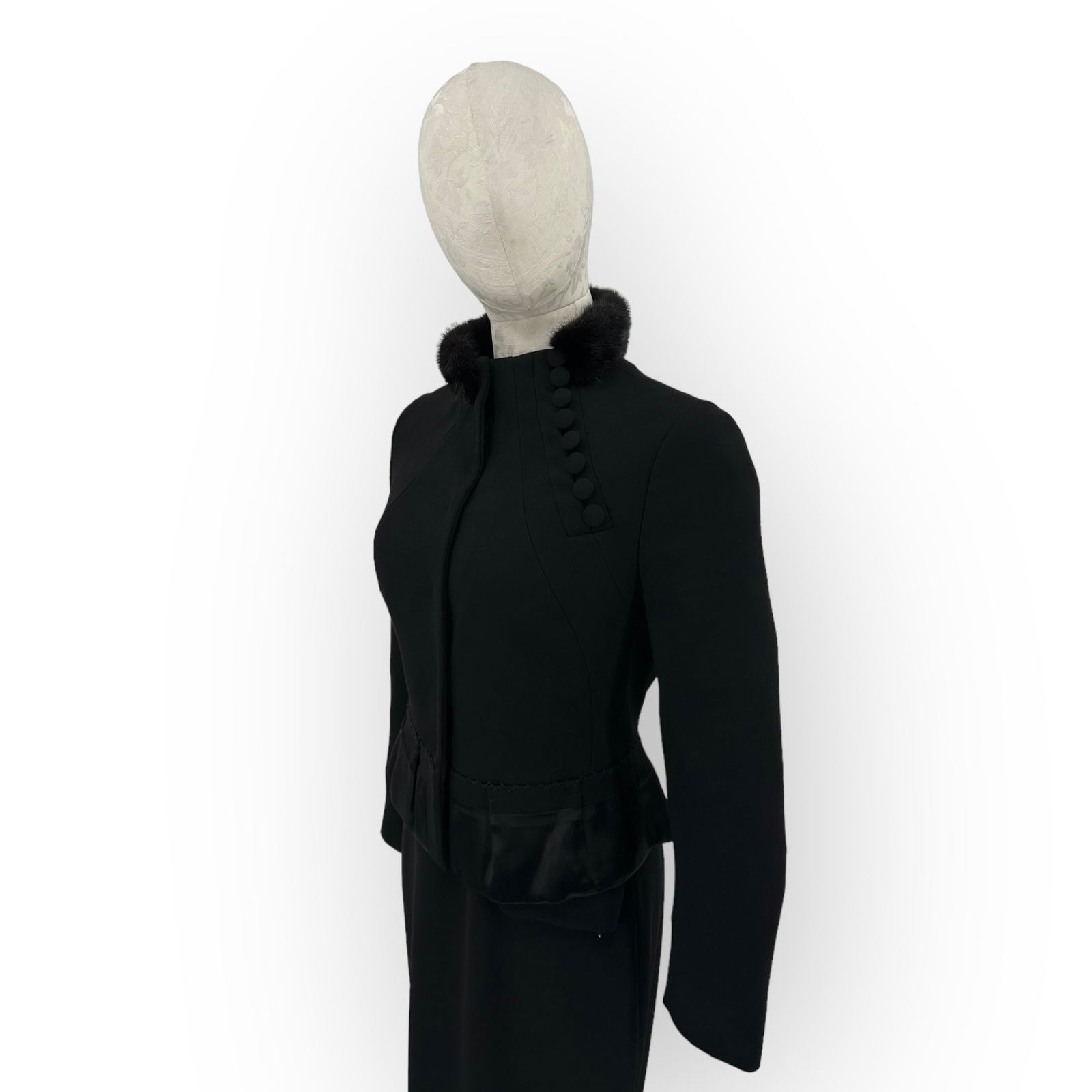 Prada Ladies Black Wool Crepe, Silk, and Mink Fur Collar Jacket: Prada black wool crepe ladies' jacket with silk detail on the peplum waist, mink fur collar, silk lining, Mandarin style collar and fasteners, pleat and stich accents; size 44. Absence of a condit