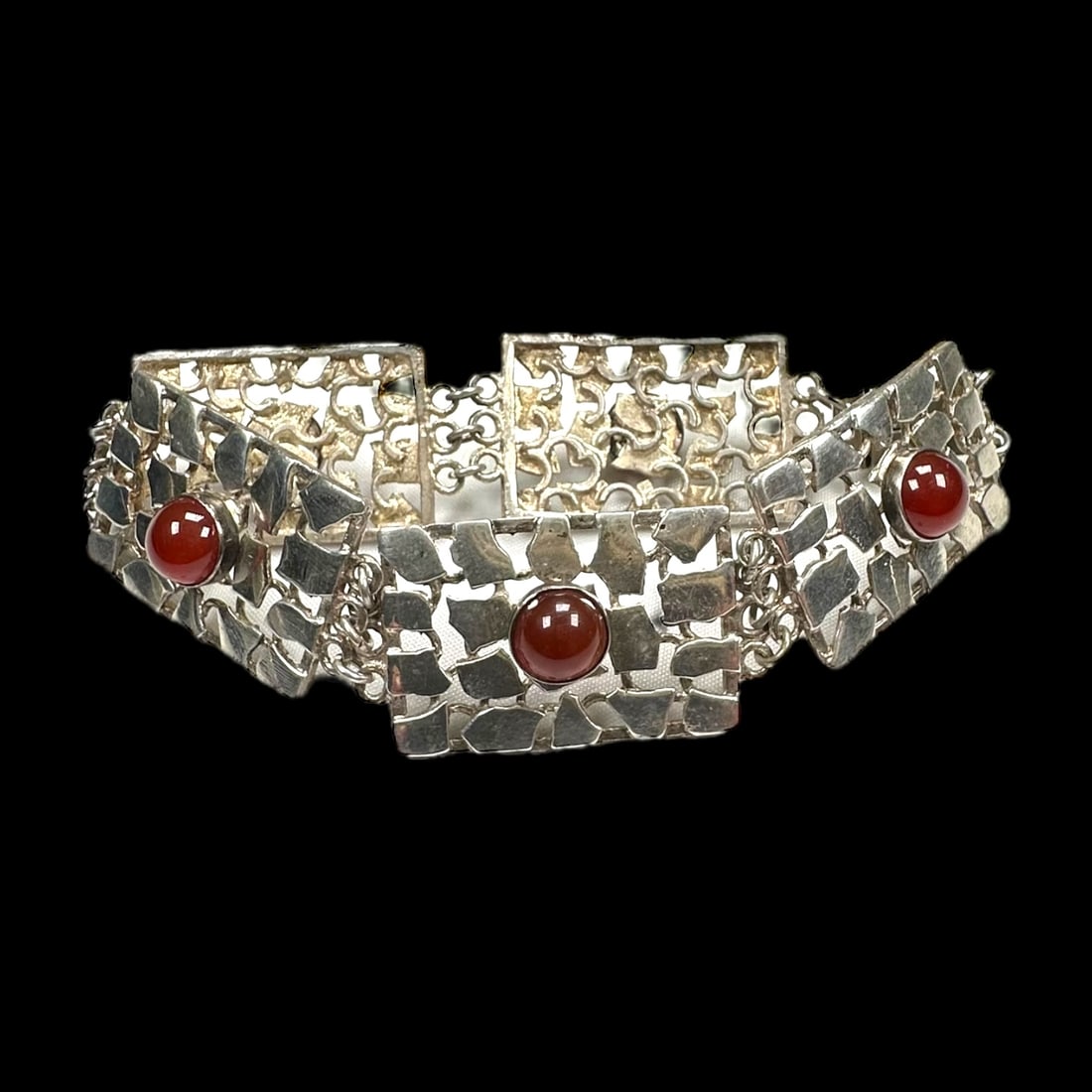 Carnelian Agate, Sterling Silver Bracelet: Featuring five round carnelian agate cabochons, set in rectangular, textured open-work links, each measuring approximately 0.80 inches in width, completed by a tongue-and groove clasp forming a 7 1/2
