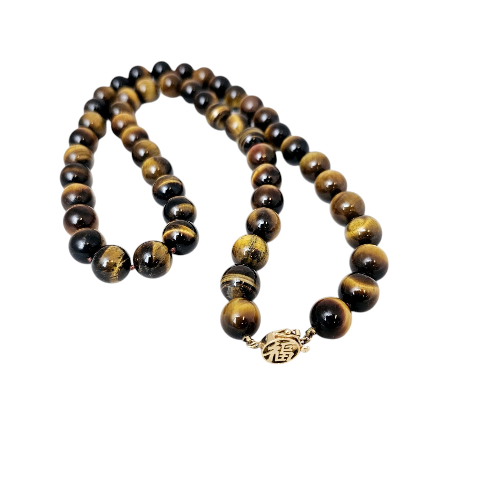 Tiger's Eye, 14k Yellow Gold Necklace: Composed of fifty-two round tiger's eye beads, each measuring approximately 12.0 mm, completed by an Asian-motif, 14k yellow gold tongue-and-groove clasp with figure-eight safety forming a 26 1/2 