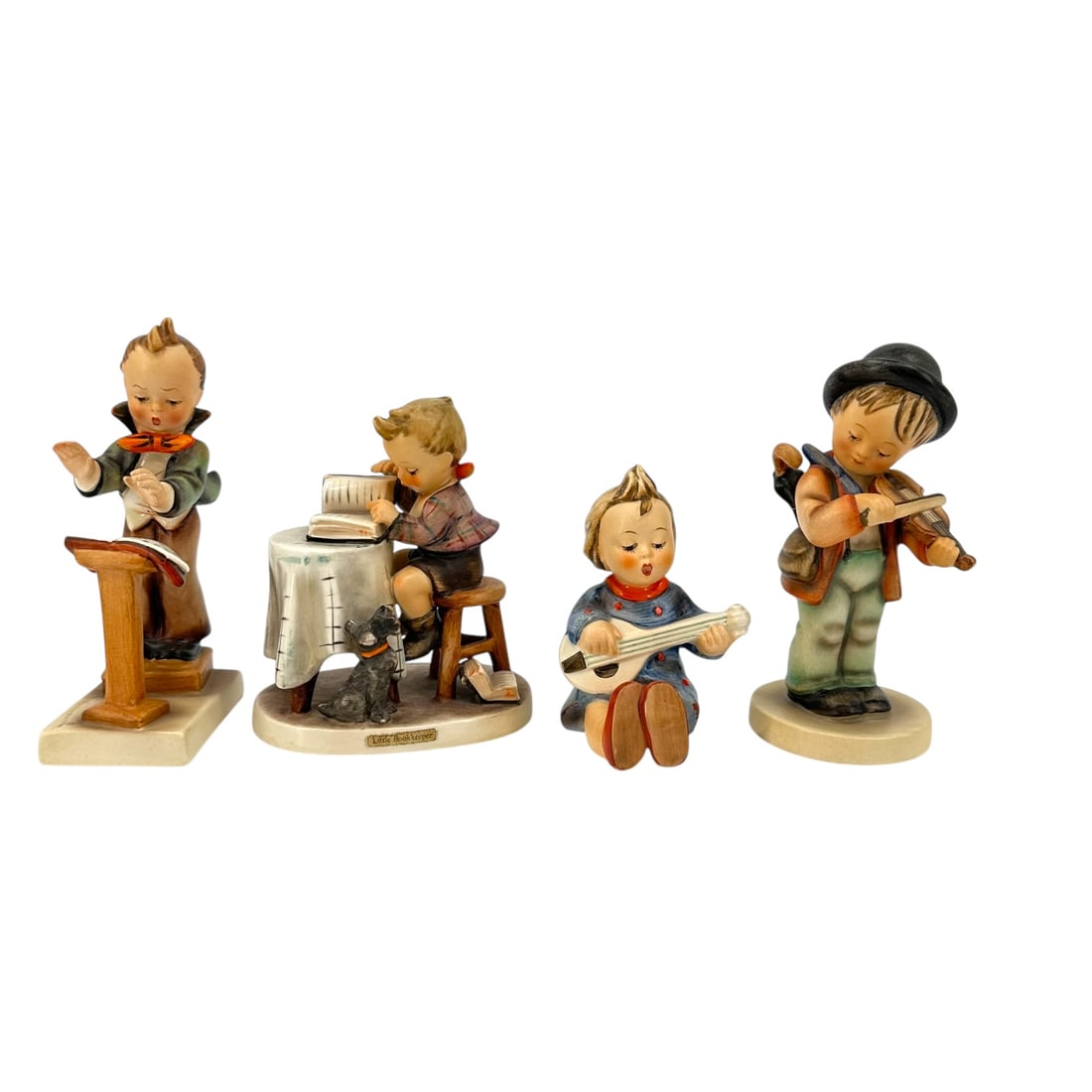 Group of 4 Hummel Figurines (1950-1972): Group of 4 Hummel figurines from 1950-1972, including a little boy playing the violin, a little boy conductor, a little boy reading a book at the table, and a little girl playing a guitar. Condition i