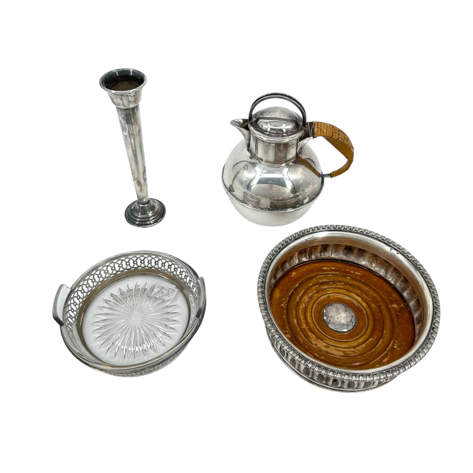 (Lot of 4) Sterling Silver Table Items: (Lot of 4) sterling silver table items including a weighted sterling bud vase, small coffee pot with woven handle, and two wine coasters. All purchases are as is, the absence of condition report does 