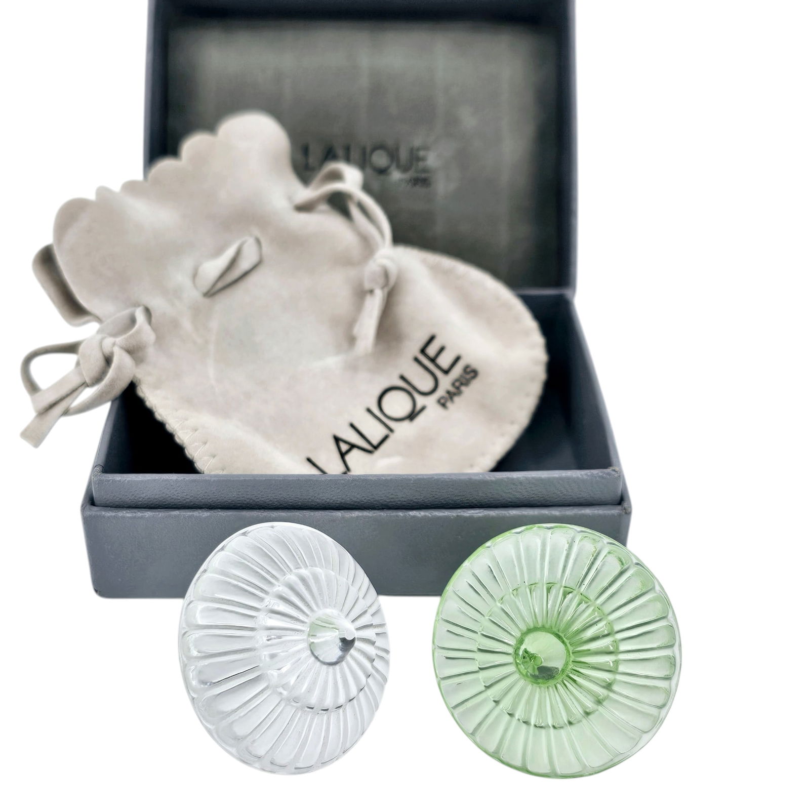 (Lot of 2) Lalique France Crystal Marguerite Toupie Spinning Tops: With box and pouch, two petite spinning tops in pale green and clear, appear in good condition. Measures 1.5" x 1.5" each. Absence of a condition report does not indicate that this lot