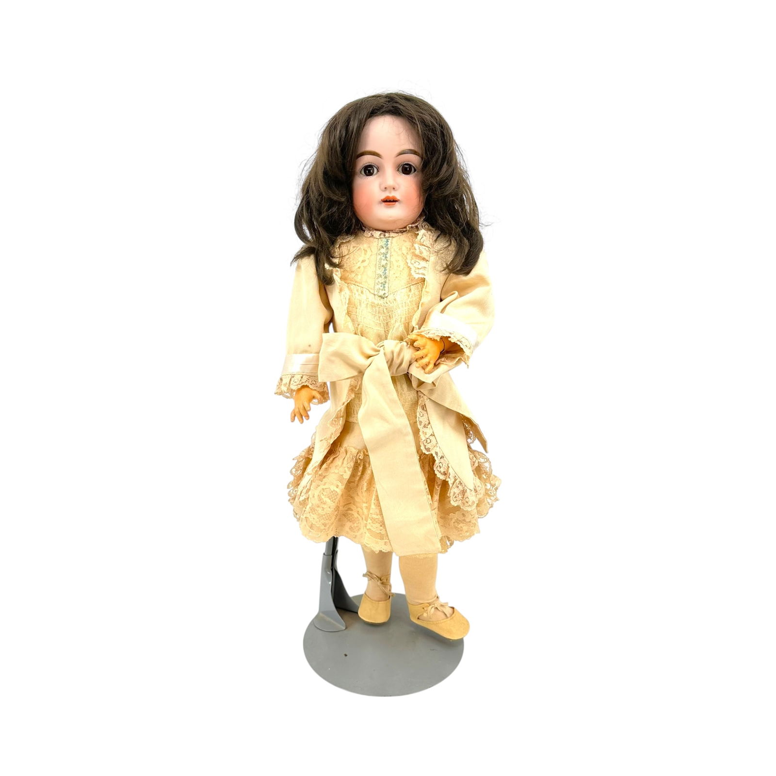 Antique German Porcelain Bisque and Articulated Composite Body Doll: Having brown sleepy eyes, an open mouth, period clothes, approx. 24" tall Lots are sold as-is. Please inquire for any additional details/condition report ideally 48 hours prior to auction. A