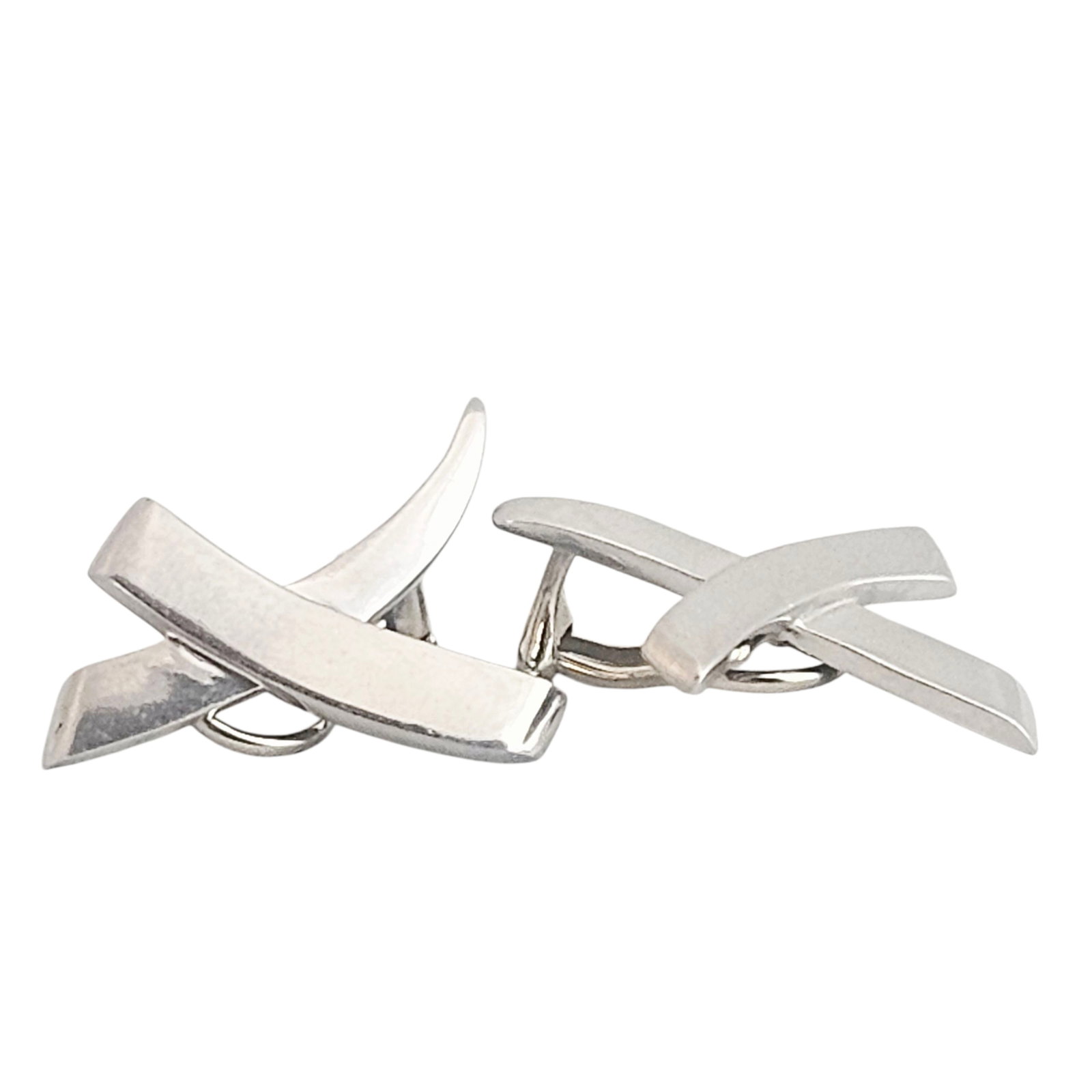 Pair of Palladium "Kiss" Ear Clips, Paloma Picasso, Tiffany & Co.: The palladium ear clips designed as a stylized "X," measuring approximately 1.05 x 0.85 inches. Gross weight: 9.8 grams. Marked "1983, Tiffany & Co., Pall, Paloma Picasso. From the