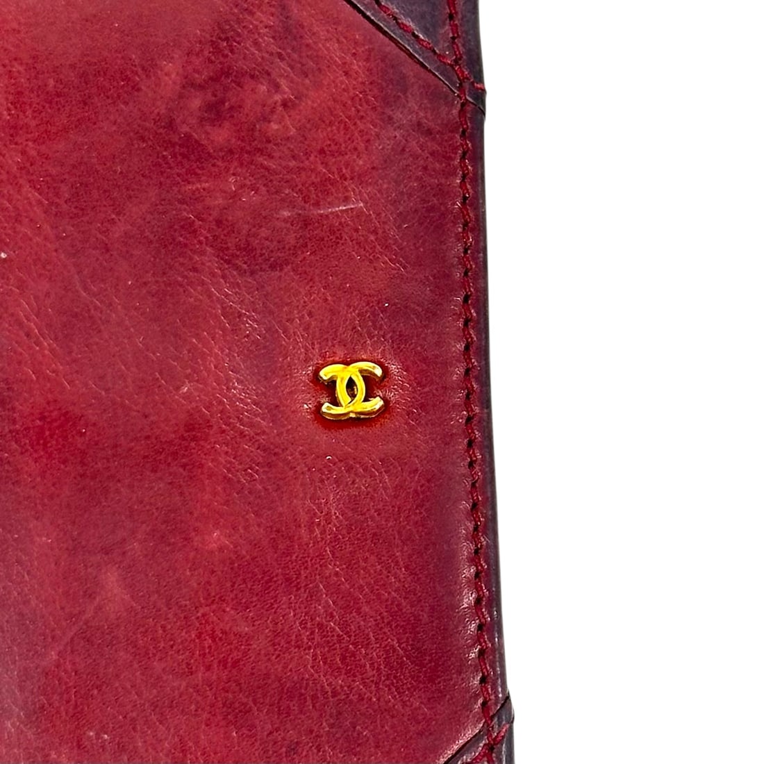 Slim Vintage Wallet/Checkbook Attributed to Chanel Burgundy Leather: Soft leather, vintage, made in Italy, small c's on front flap. Measures 7" x 3.25". Worn condition consistent with age and wear. Absence of a condition report does not indicat