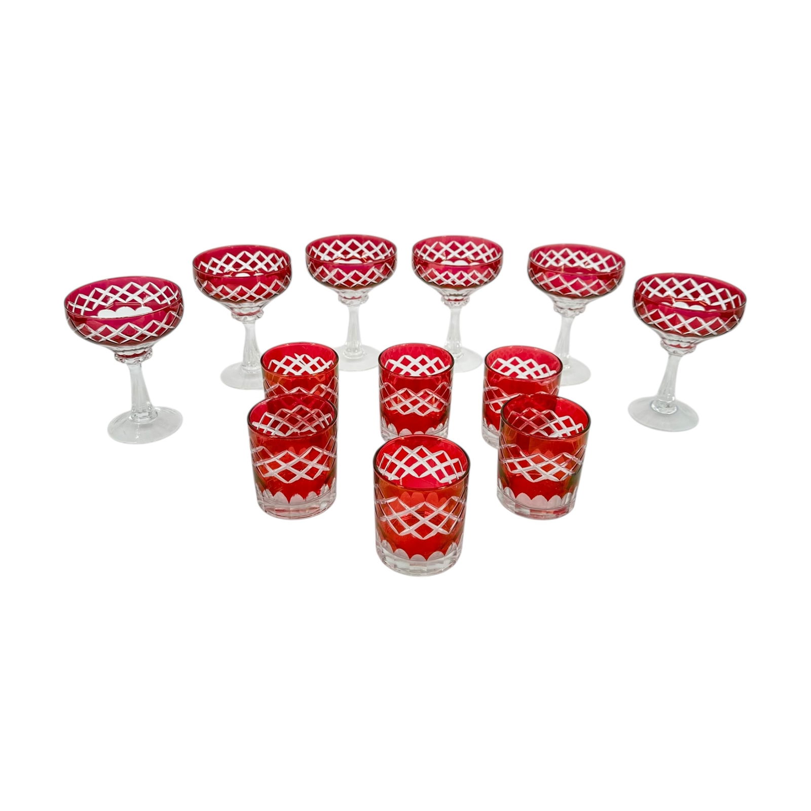 (Lot of) 12 Cranberry Cut to Clear Glasses: (Lot of) 12 cranberry cut to clear glasses, including 6 champagne coupes and 6 small water glasses. Condition is good, slight fading on the cranberry coloring.