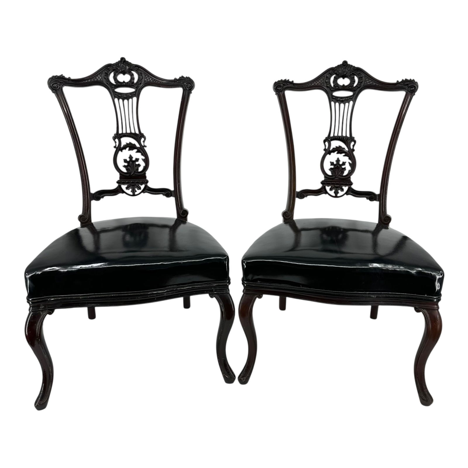 A Pair of Queen Style Side Chairs: A pair of Queen style side chairs, with scrolled arched backs above lyre form splats and trapezoidal seats raised on cabriole legs. Measures approximately 32 1/2 in H x 18 in W. Condition: repair to o