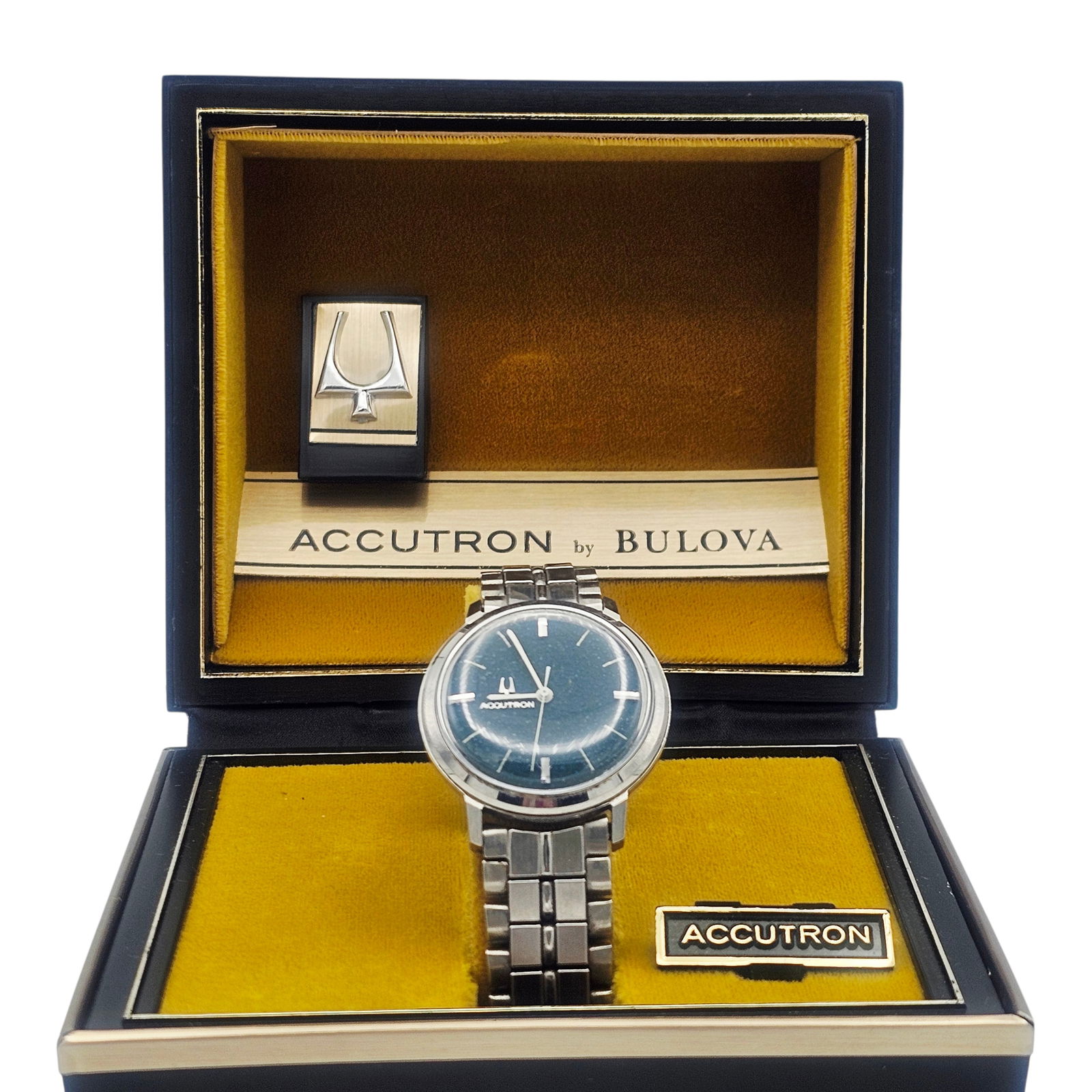 Gent's Bulova Stainless Steel Accutron '214' Wristwatch: DIAL: Round, textured blue, applied silver-tone and white stick hour markers, white baton hands, white center seconds sweep, Accutron. MOVEMENT: Quartz, cal 214. CASE: Round, stainless steel, bac