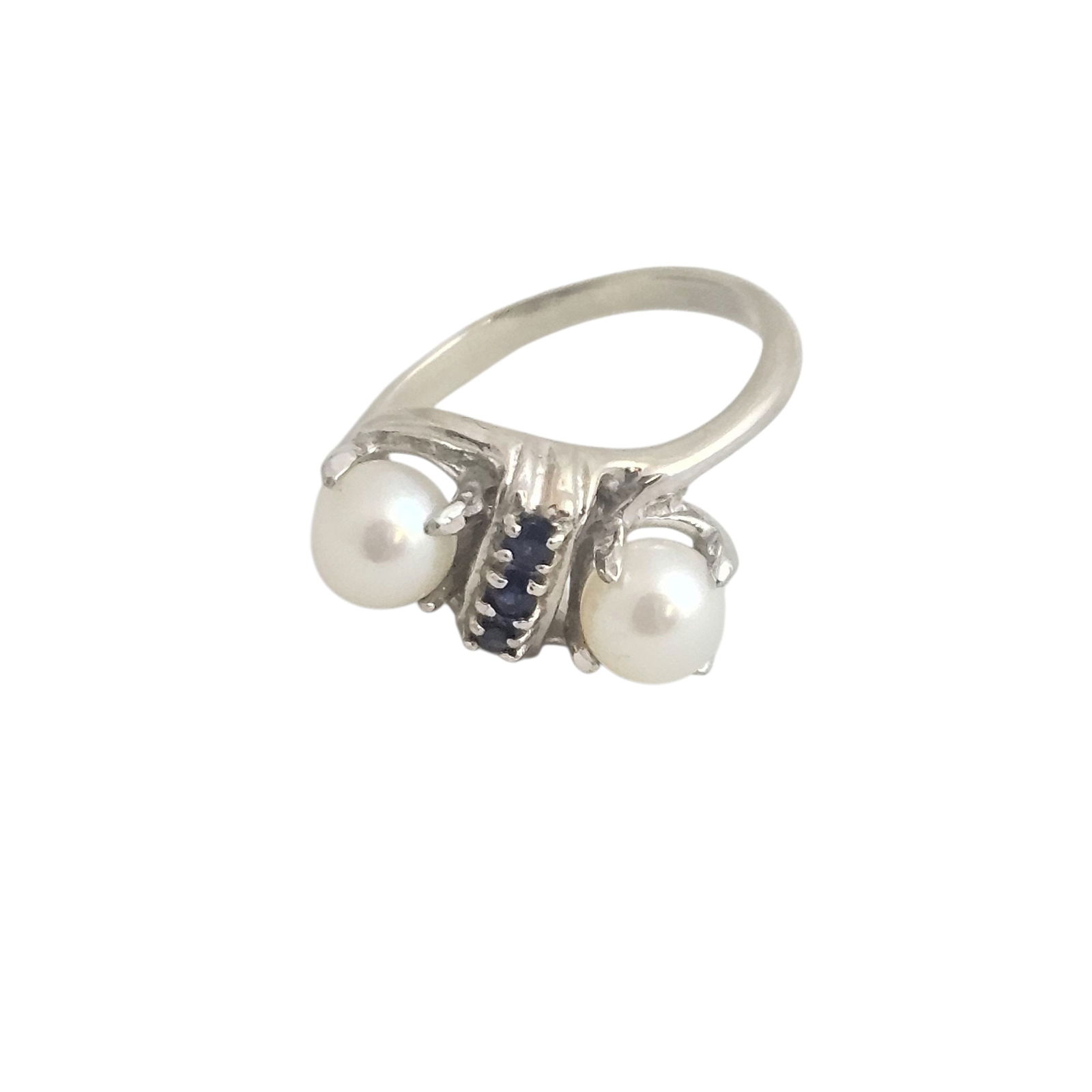 14k White Gold Bypass Pearl & Sapphire Ring: Marked 14k, appears vintage. Three sapphires. 3.58 gram total weight. Approximately 5.5 ring size. Absence of a condition report does not indicate that this lot is in perfect condition. Please re
