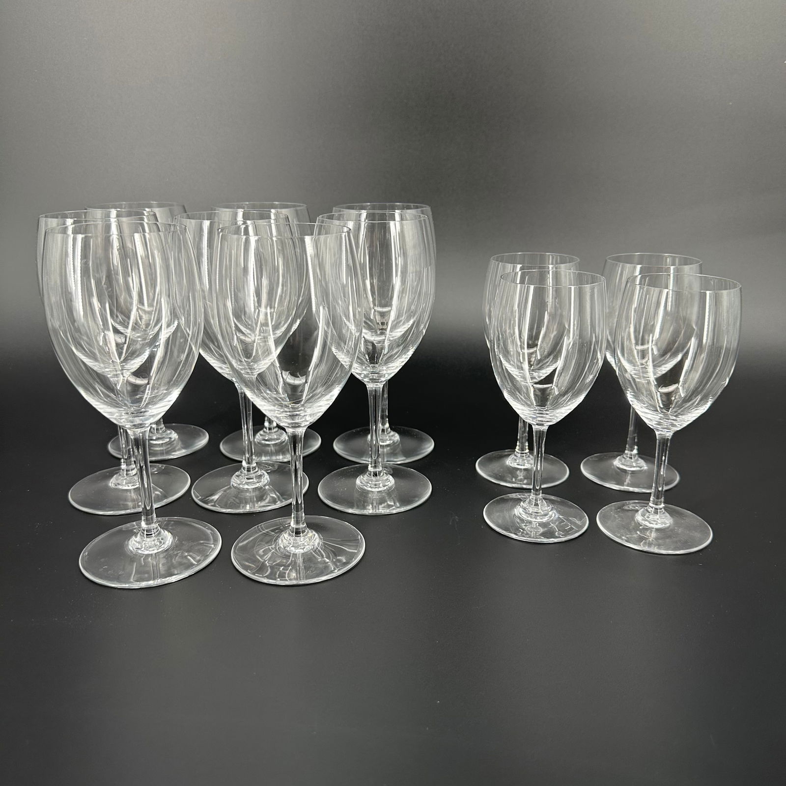 (Lot of) 12 Baccarat Wine Glasses: (Lot of) 12 Baccarat wine glasses, 8 tall glasses and 4 short glasses. All stamped at the bottom of the glass. Condition is good, no signs of wear and tear.