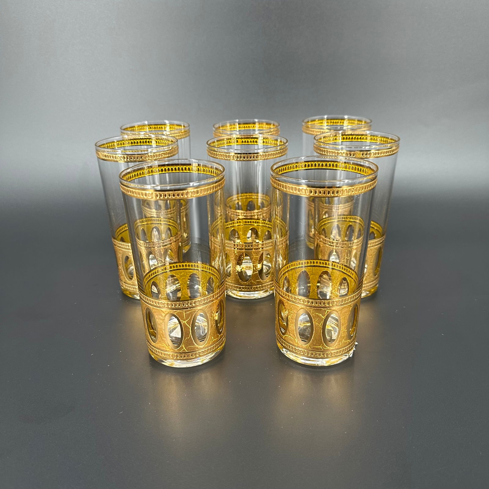 (Lot of) 8 Culver Ltd "Antigua" Highball Glasses: (Lot of) 8 Culver Ltd "Antigua" highball glasses with gold detailing around the base and rim. Signed Culver Ltd. Measures approximately 5 1/2 in H x 2 3/4 in D. Condition is very good, sligh
