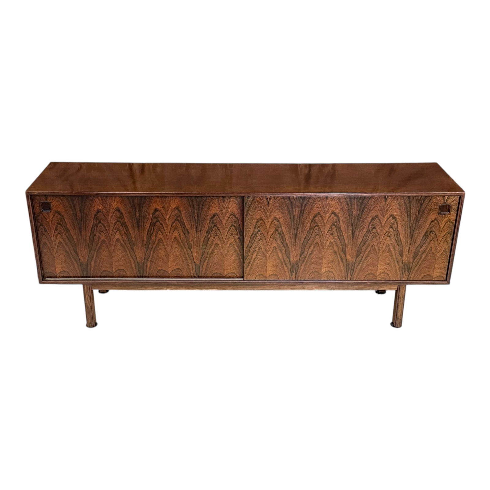 Mid Century Rosewood Sideboard: A Mid Century Modern rosewood credenza, possibly Danish, featuring sliding doors, multiple drawers including some felt lined.