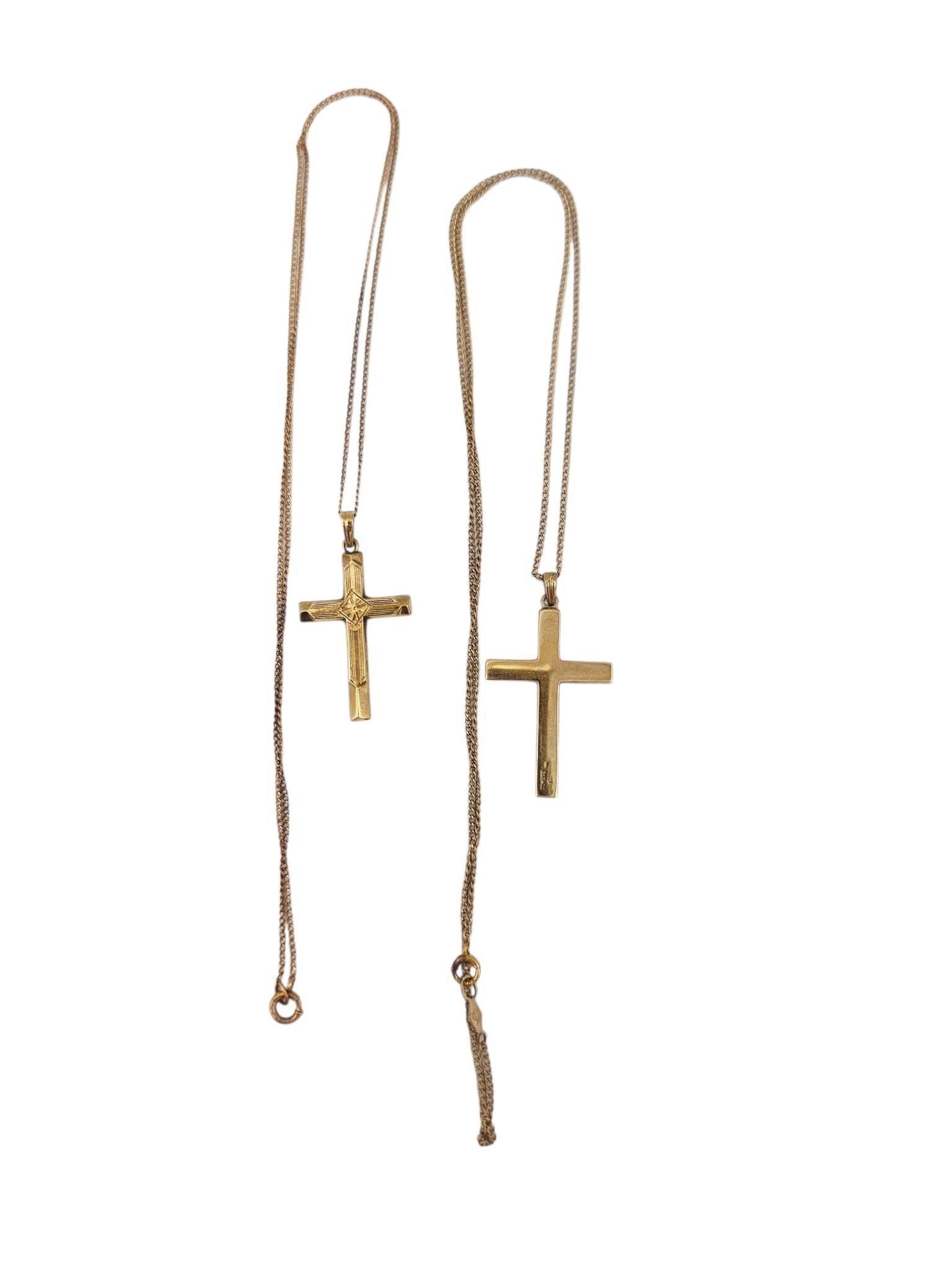 Two 10k Yellow Gold Cross Necklaces: Pair of 10k yellow gold pendants, each suspended by an 18 inch, 10k yellow gold curb link chain, including one cross measuring approximately 1.30 x 0.70 inches; together with one c
