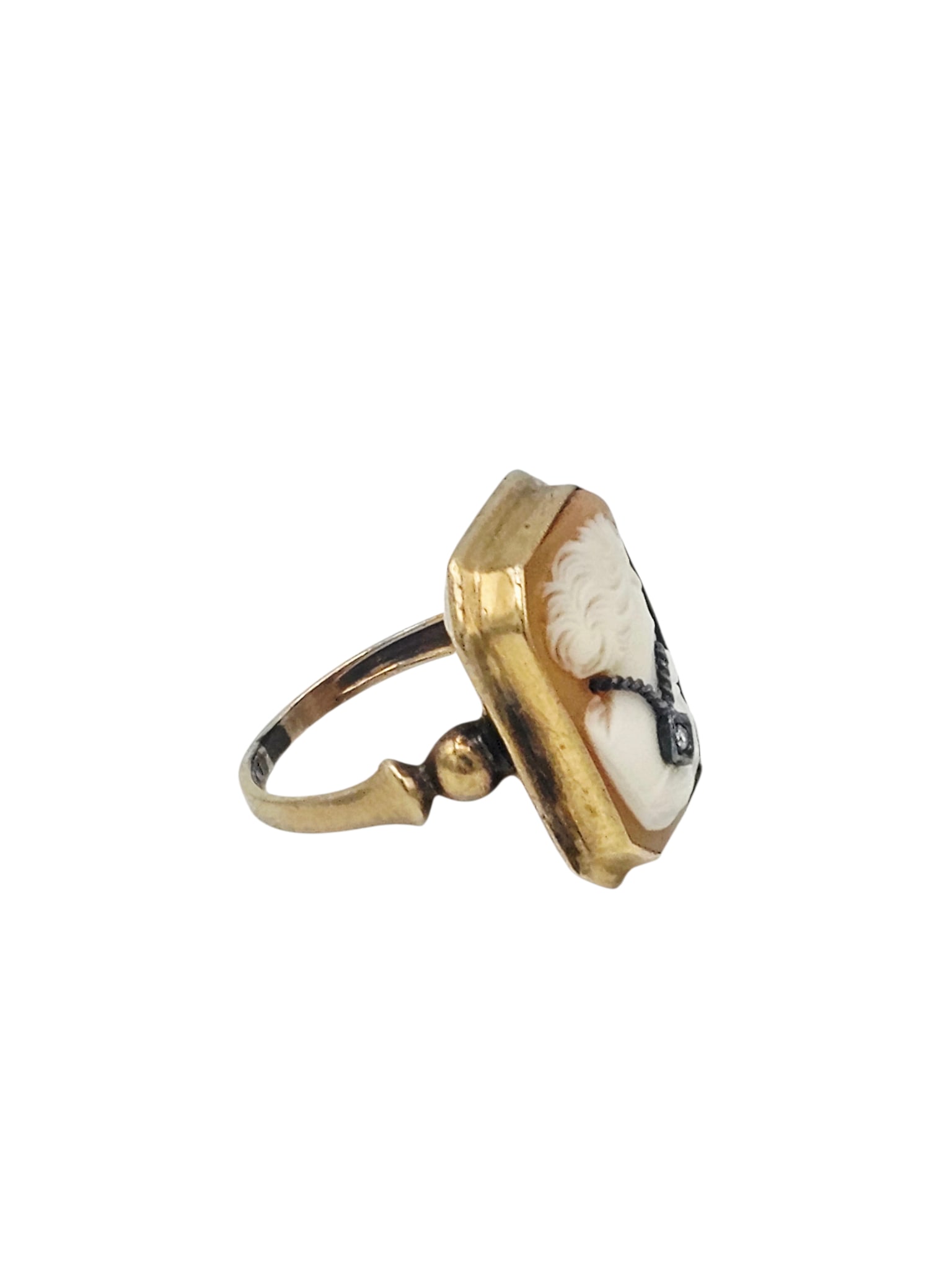 Shell Cameo, Diamond, 10k Ring: Featuring a rectangular shell cameo depicting a beauty in profile, her necklace highlighted by one single-cut diamond weighing approximately 0.01 ct., set in a 10k yellow gold ring mounting, size 5. G