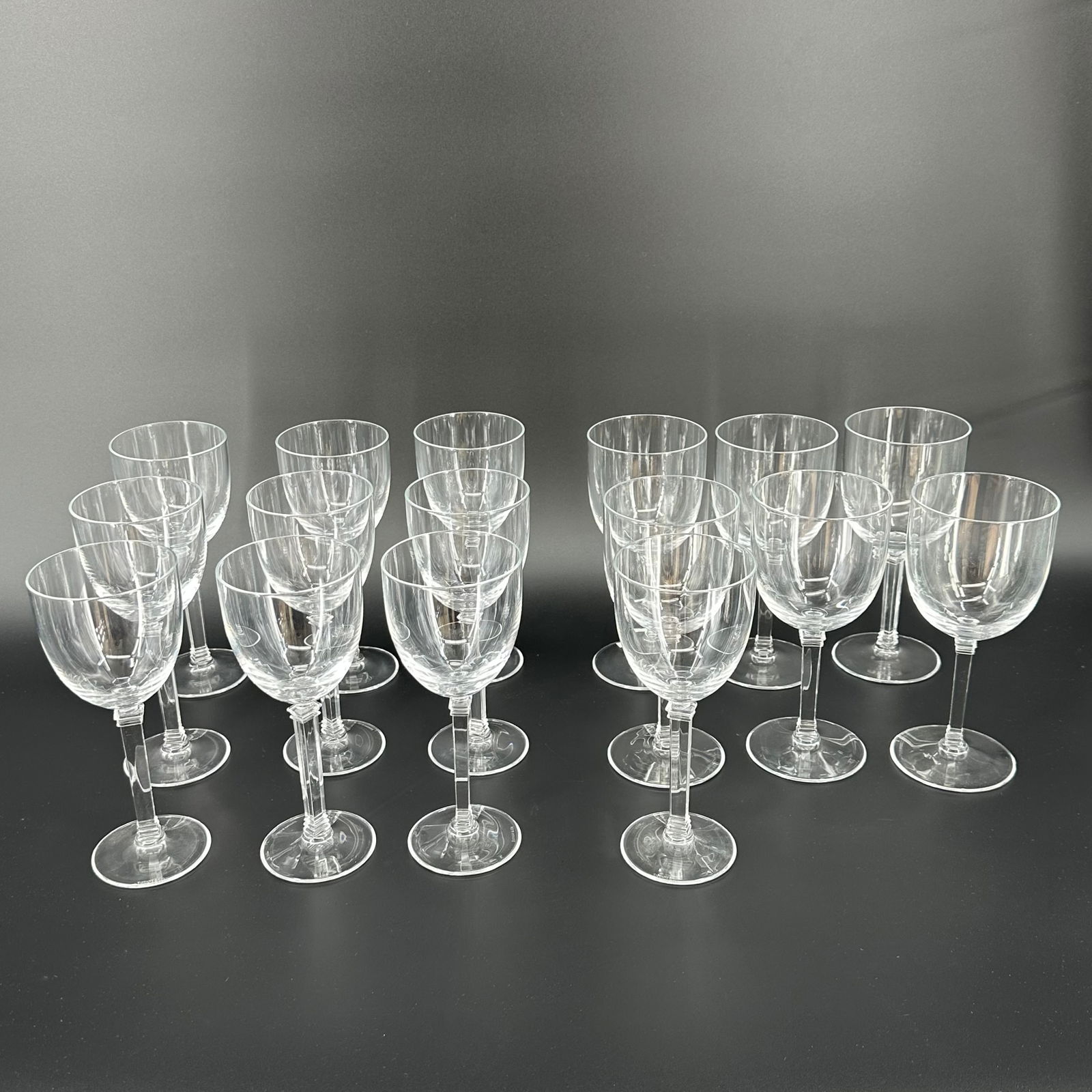 (Lot of) 16 Tiffany & Co. Clear Glass Wine Stems: (Lot of) 16 Tiffany & Co. clear glass wine stems with square stem bases, each signed at the bottom.
